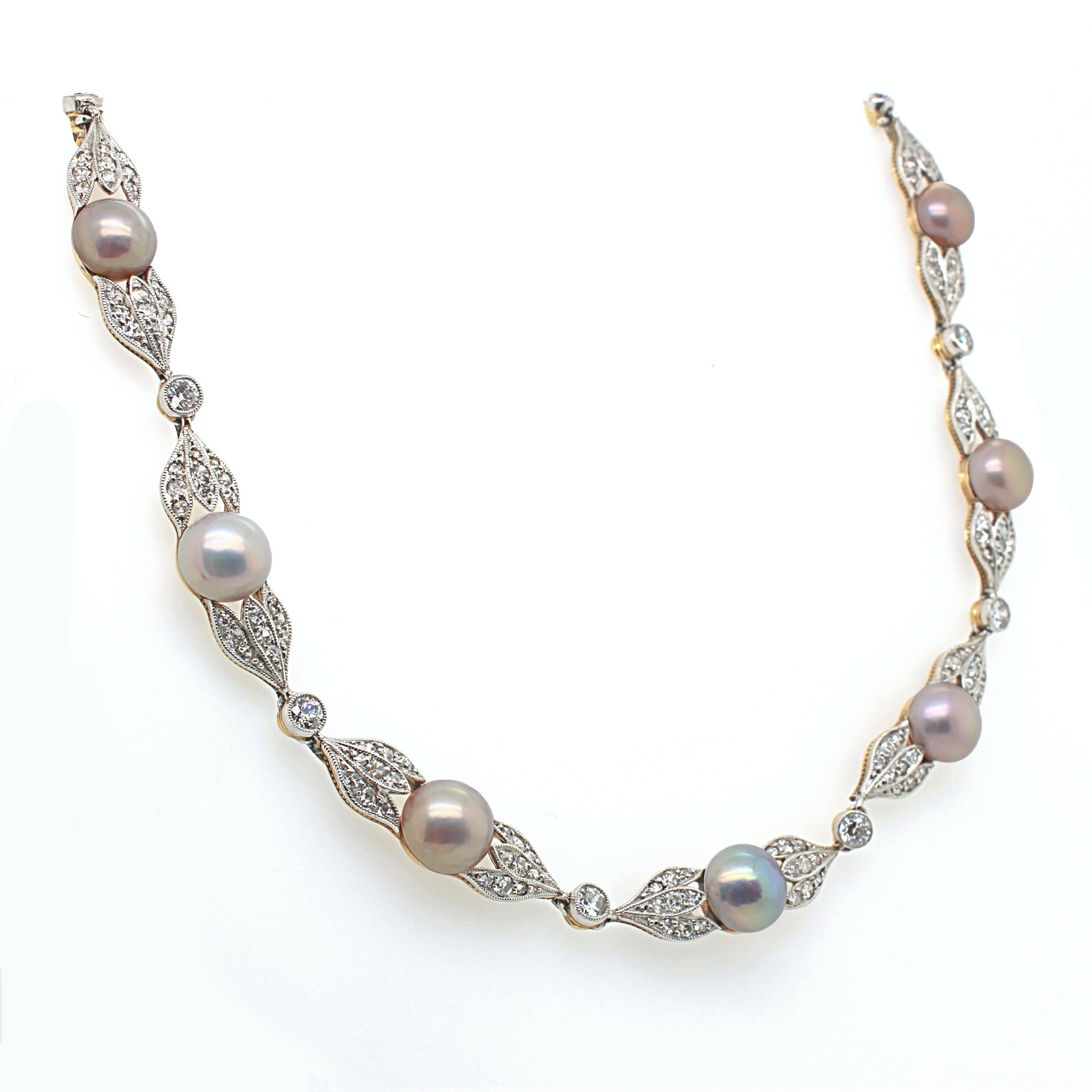 A colourful natural pearl and diamond necklace, Edwardian, ca. 1900. The necklace consists of 16 panels, each set with a natural pearl button and old cut diamonds, weighing approximately 5 carats in total. The natural pearls are multicoloured with