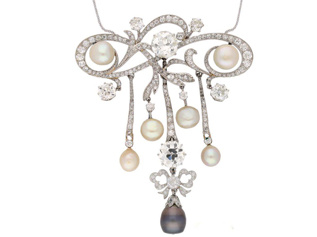 Edwardian natural pearl and diamond pendant/brooch. An impressive convertible pendant/brooch, set to either side with two natural saltwater pearls and suspending four additional natural saltwater pearls and a natural saltwater grey pearl with a