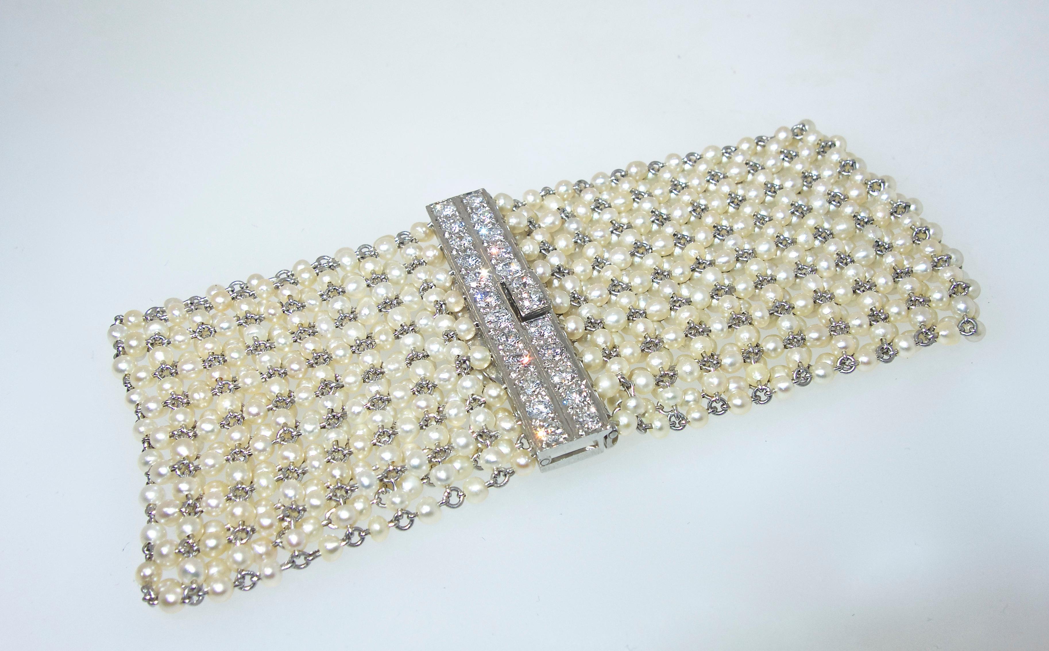 Natural pearls strung on platinum and accent with a fine diamond clasp.  This platinum bracelet made in the early 20th century is 7.25 inches long and 1.5 inches wide.  The natural oriental pearls are all well matched, circular and display a fine