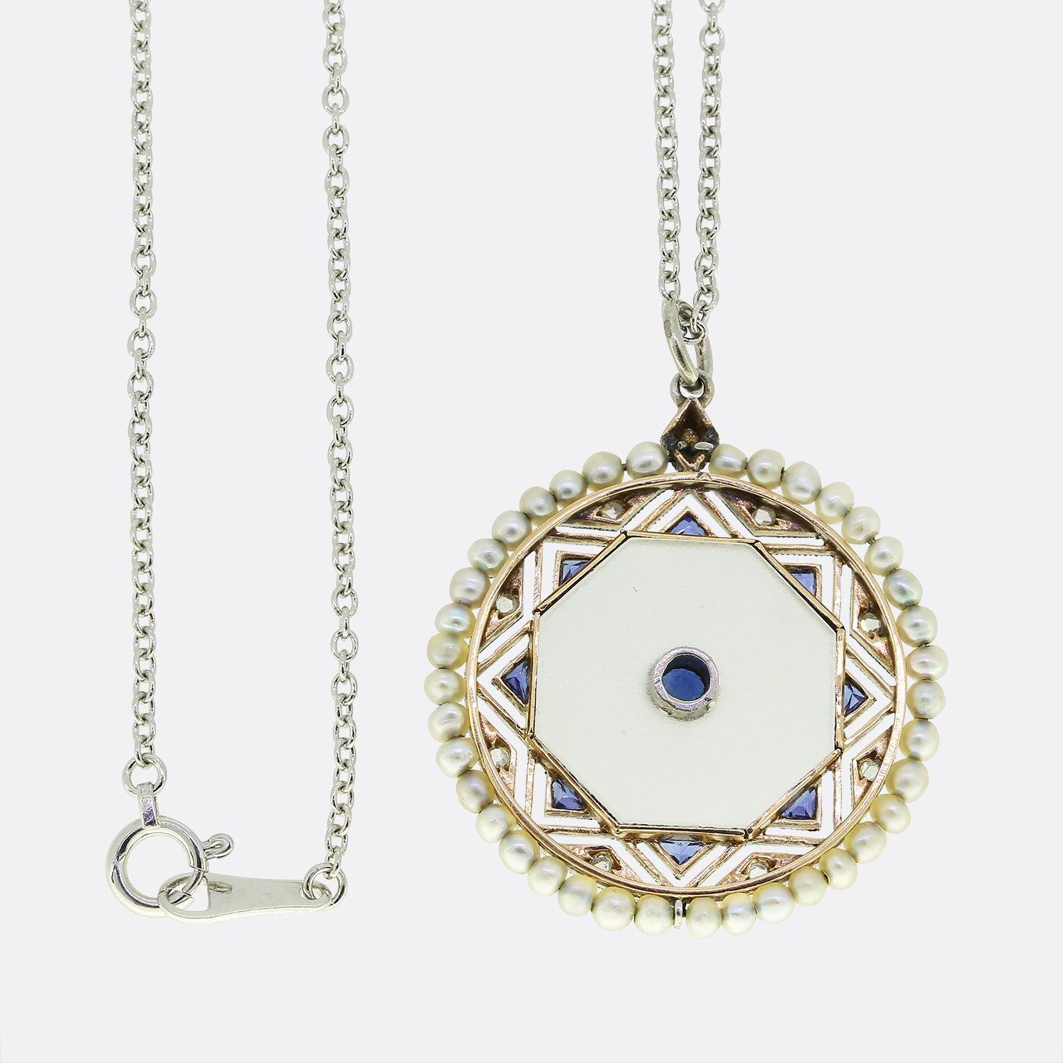 This is a pendant necklace dating back to the Edwardian era. The necklace features a central piece of rock crystal which has been set with a round cut sapphire. This is then surrounded by eight triangular shaped sapphires, eight rose cut diamonds