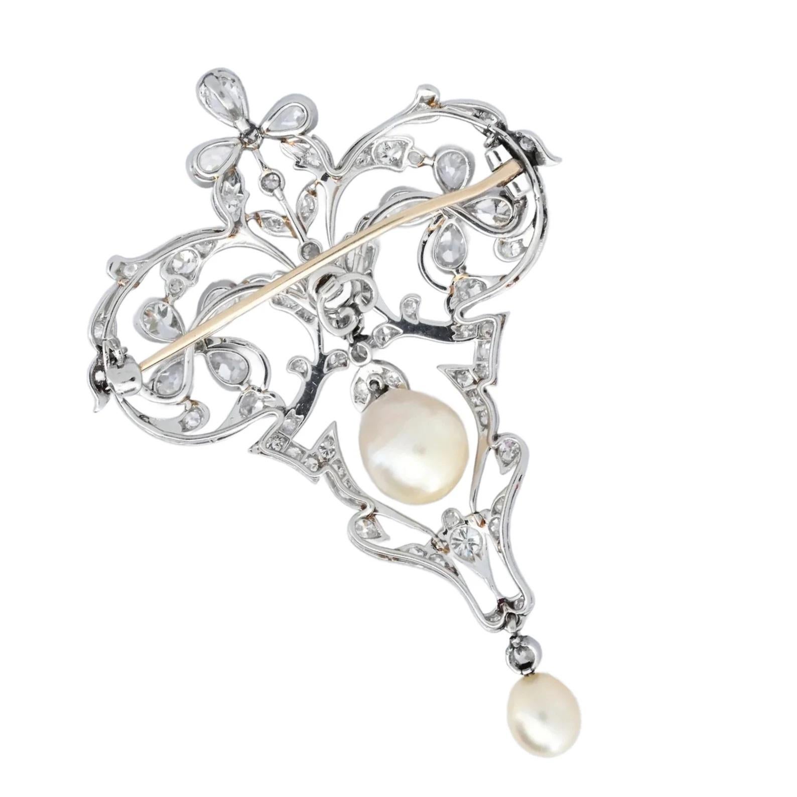 An exquisite natural pearl and diamond convertible pendant brooch in platinum.

Centered by cream colored Natural Saltwater Pearls measuring 8.93 by 8.01mm and 6.00mm. The pearls of even cream color with strong lustre and smooth surfaces.

Set in