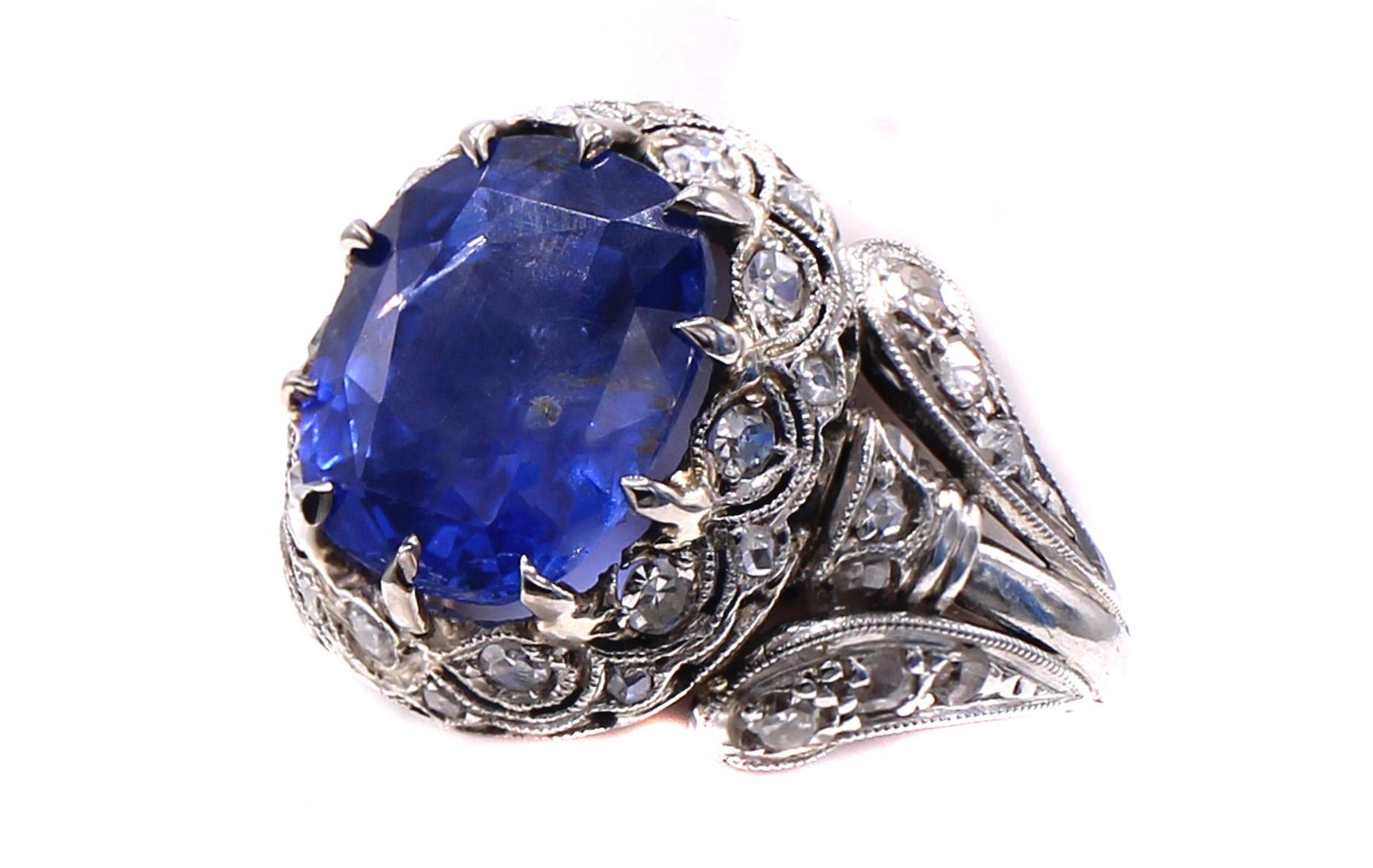 A beautiful cushion cut natural sapphire weighing 3.49 carats is the center piece of this gorgeous Edwardian ring from ca 1910. The corn flower blue sapphire has a report from the AGL stating that the origin is Ceylon/Sri-Lanka and is free of any