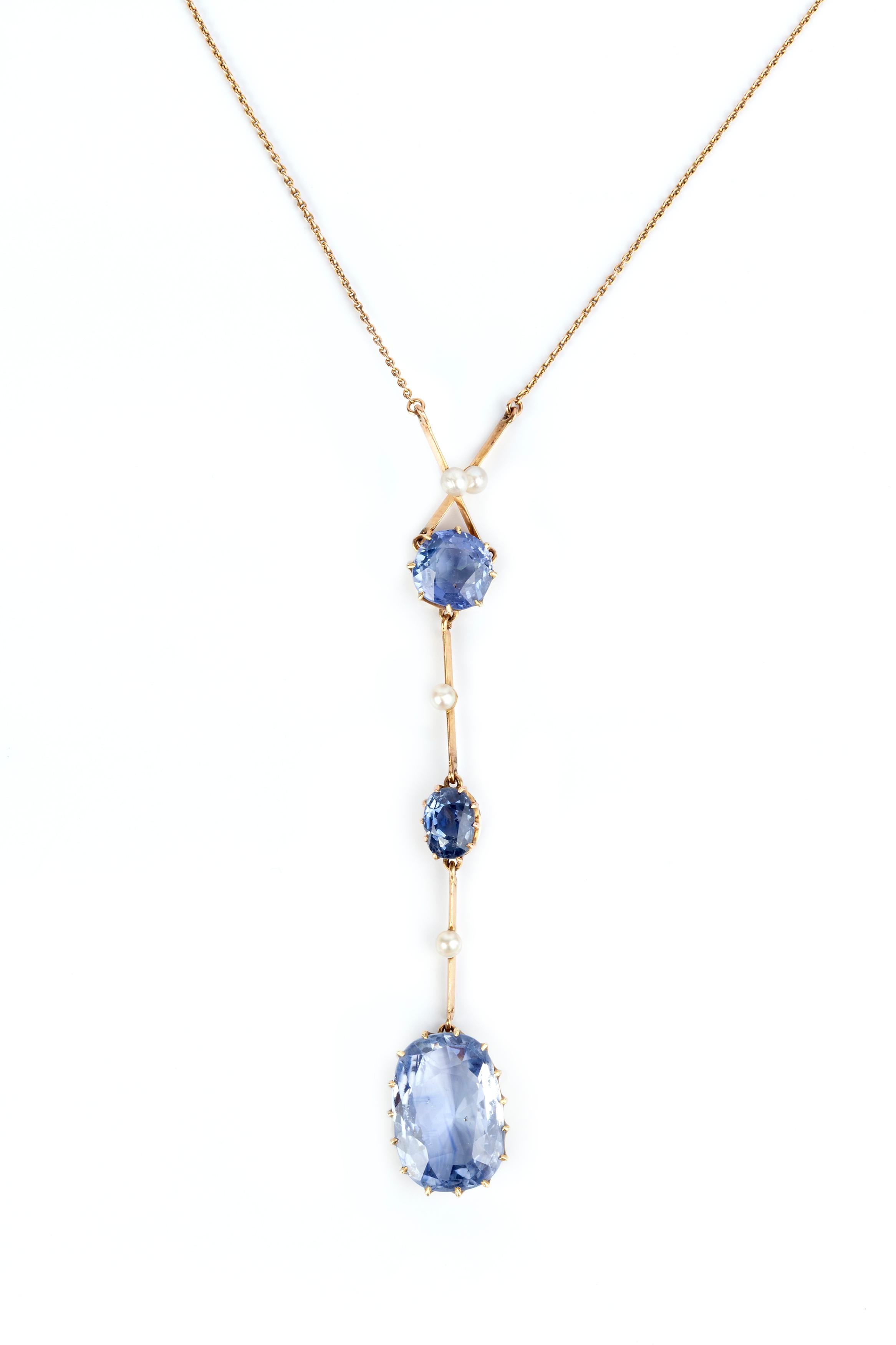 A Ceylon blue natural unheated sapphire pendant set with three natural sapphires and natural seed pearls on an 18 karat gold chain. The largest sapphire is 5.5cts and the circular sapphire is 1.6cts smaller sapphire 0.8cts. 