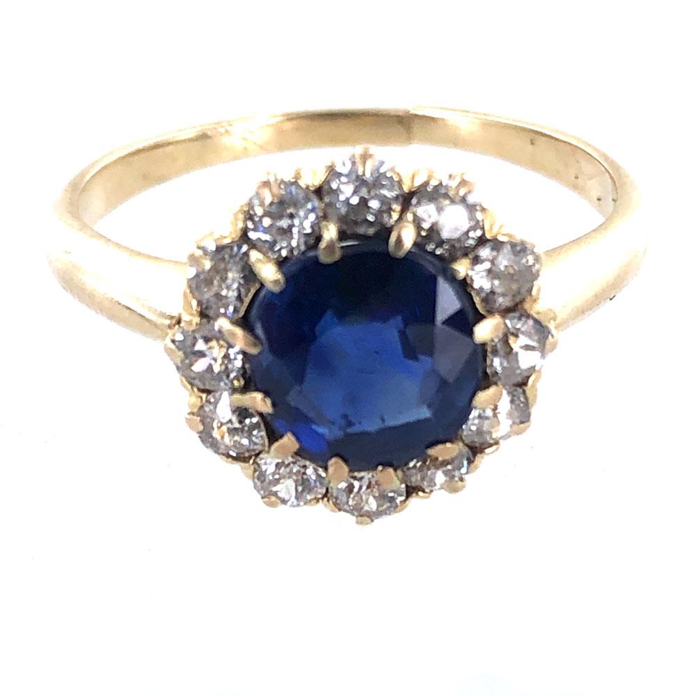 Exquisite Antique Blue Sapphire Diamond Ring. The center 1.56 carat blue sapphire has a certificate from the AGL stating no heat or treatment has been applied to the sapphire. Surrounding the bright blue sapphire are 12 Old Mine Cut Diamonds