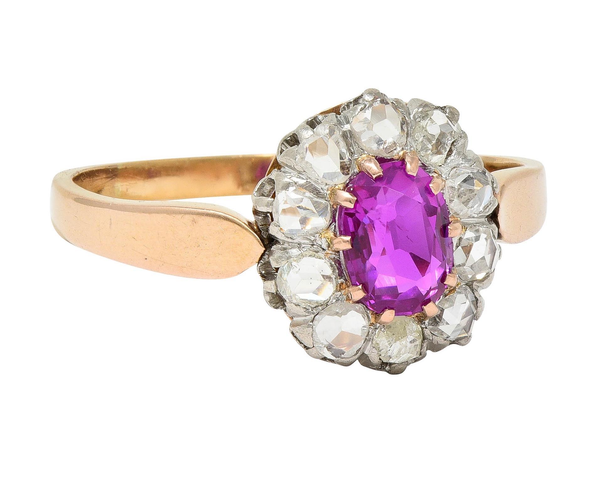 Centering an oval cut sapphire weighing 1.00 carat - transparent medium purple-pink in color 
Natural Burmese in origin with no indications of heat treatment 
Prong set in platinum-topped head with a halo surround of rose cut diamonds 
Weighing