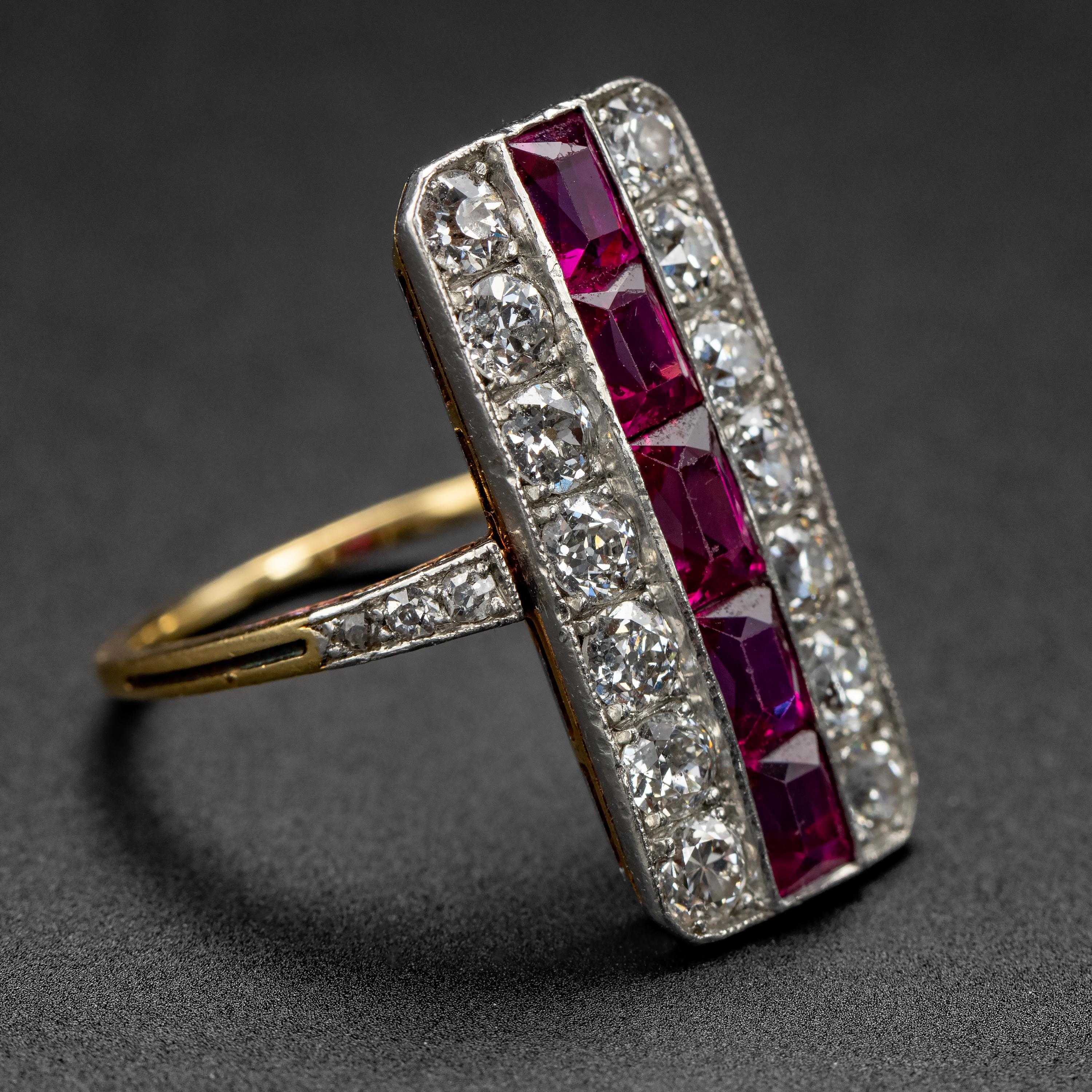 This spectacular Edwardian no-heat Burma ruby and diamond ring features a crisp central row of vivid pinkish-red hand-cut baguette unheated rubies from Burma that total between 2.05 and 2.15 carats, and two rows of bright white and firey eye-clean