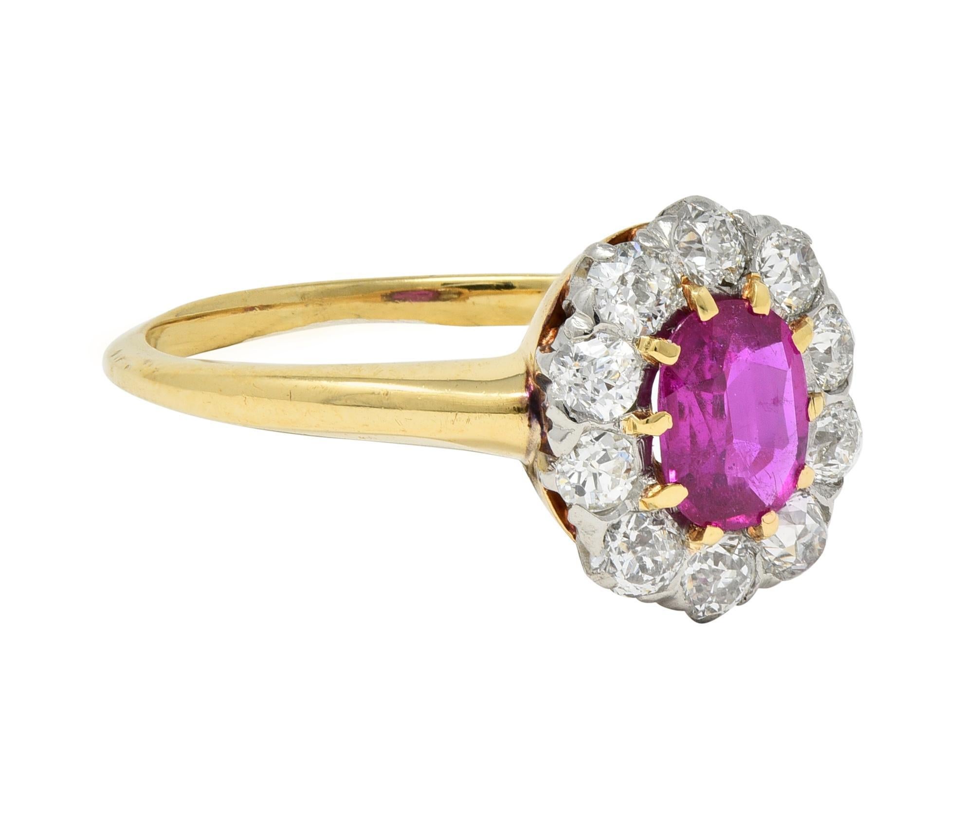 Centering an oval cut ruby weighing 0.62 carat total - transparent medium purplish red
Natural Burmese in origin with no indications of heat treatment - set with gold prongs
Accented by a halo surround of old European cut diamonds prong set in