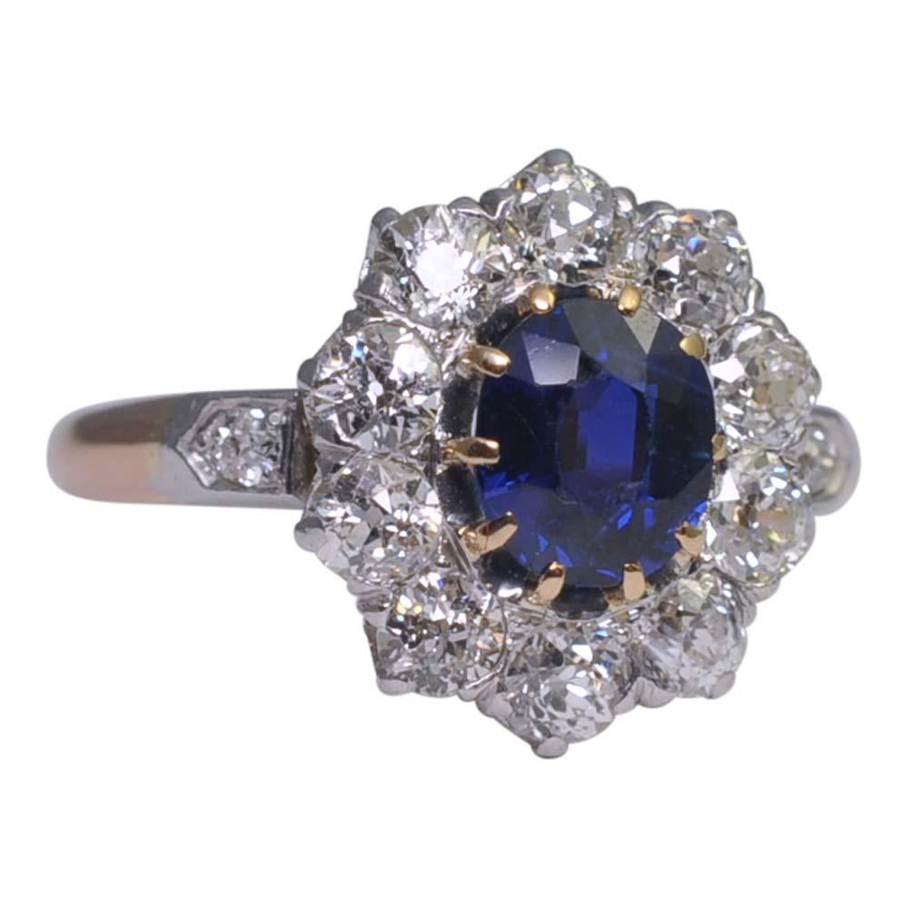 Beautiful Edwardian sapphire and diamond ring;  the oval royal blue sapphire is certificated as No Heat,  weighs 1.11ct and is surrounded by a halo of Old European cut diamonds weighing 1.02ct and diamond set shoulders.  The diamonds are set in