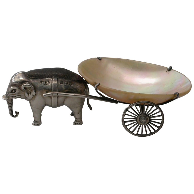 A rare Edwardian novelty silver pin cushion made in the form of an elephant pulling a mother of pearl cart.

By Adie & Lovekin, Birmingham, 1910

In fine original condition with no damage or repair

Measures: Height 33 mm (1.30 inches)
Width
