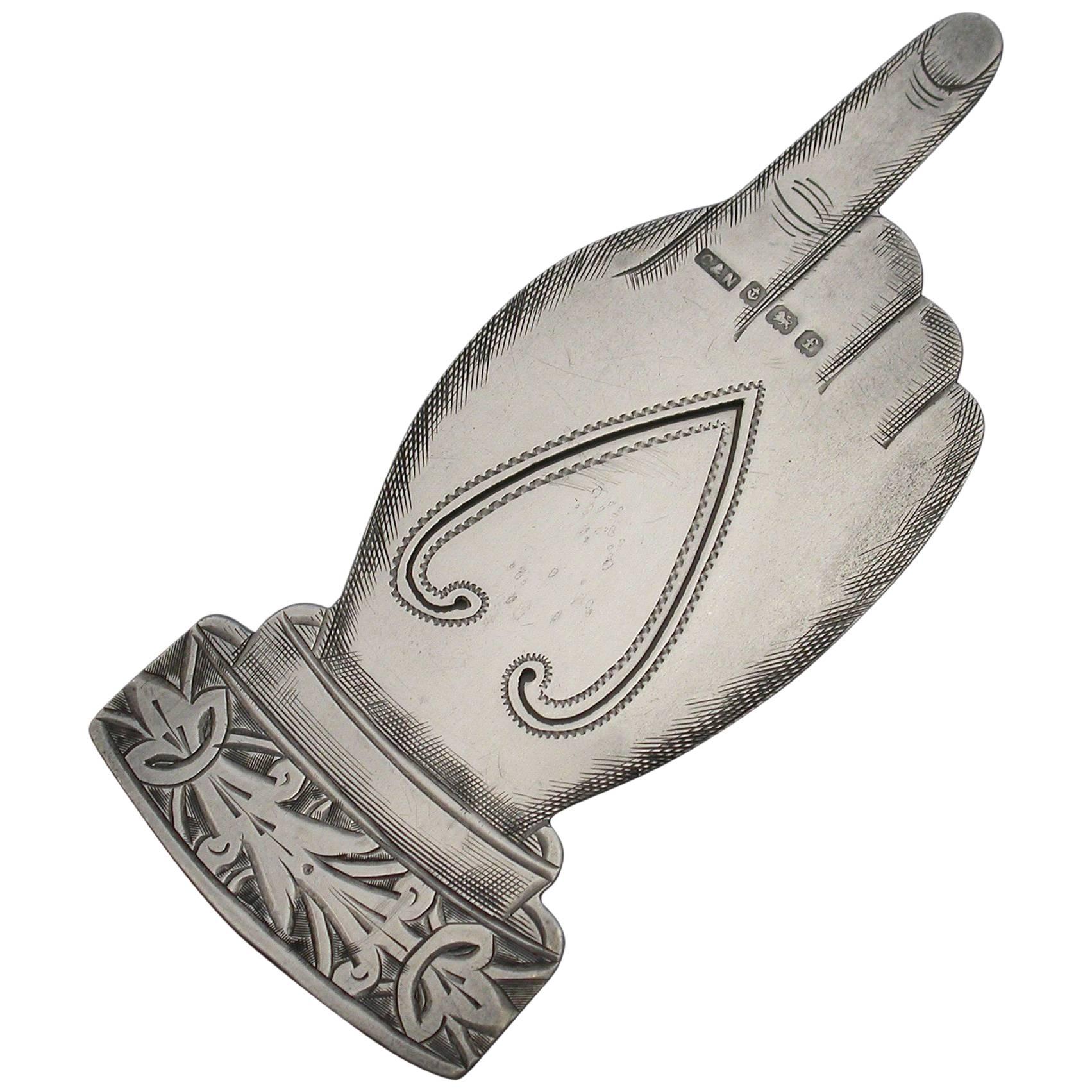An Edwardian novelty silver bookmark modelled as a hand with a pointing index finger. Fine bright-cut engraved decoration to the cuff and lifelike engraving to the hand itself.

By Crisford & Noris, Birmingham, 1905

In good condition with no