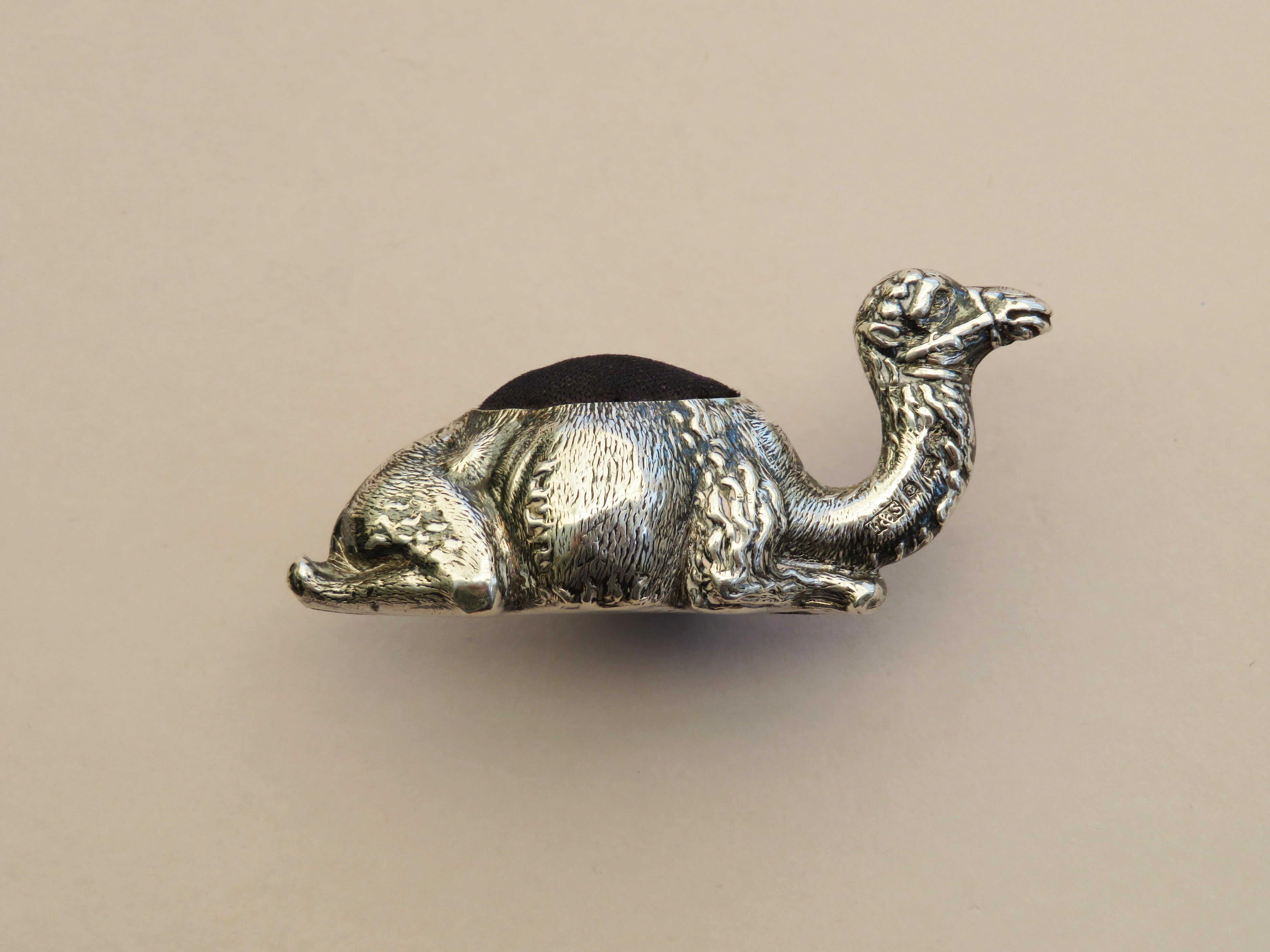 A rare Edwardian novelty silver pin cushion made in the form of a recumbent camel, complete with original cushion and the smaller of the two know sizes.

By Levi & Salaman, Birmingham, 1903

In good condition with no damage or