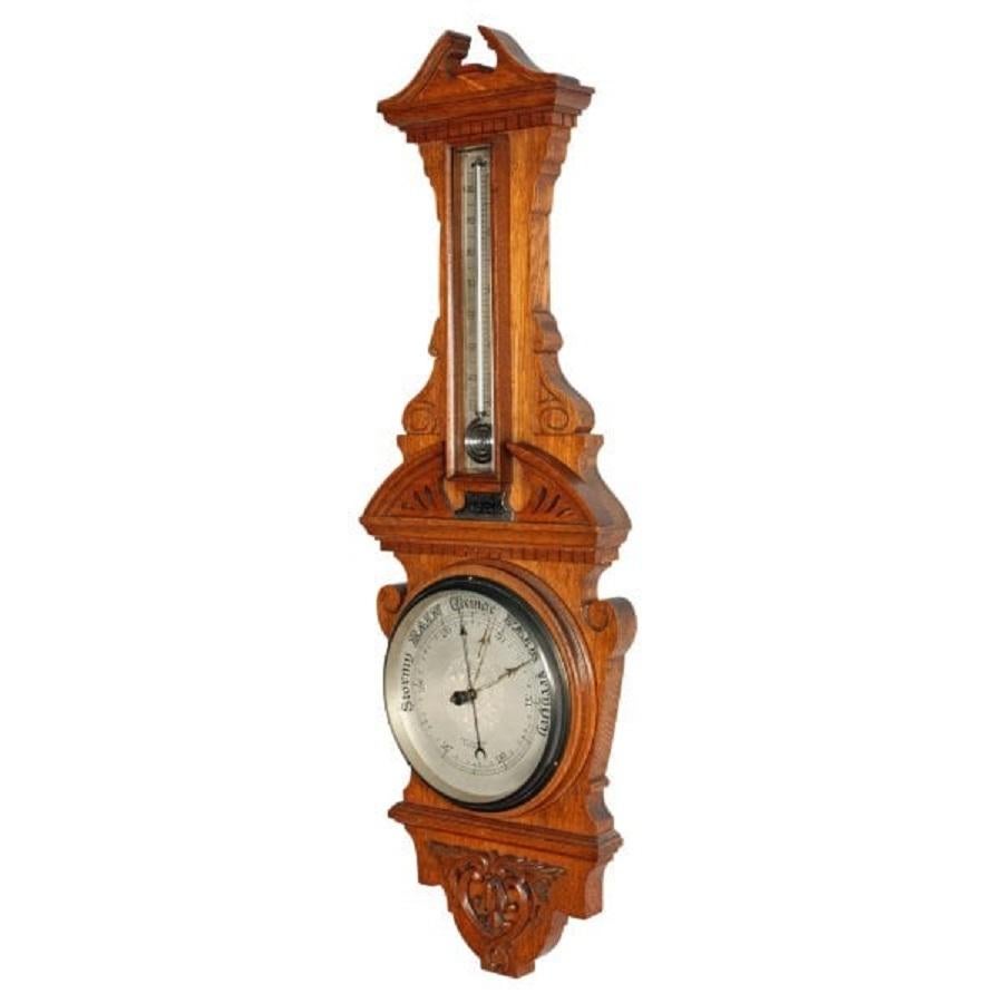 A fine example of an Edwardian oak cased aneroid barometer.

The barometer has a thermometer with an unusual curled reservoir and is held in an oak glass fronted case.

The silverised dial is behind a glass face has the barometric readings and