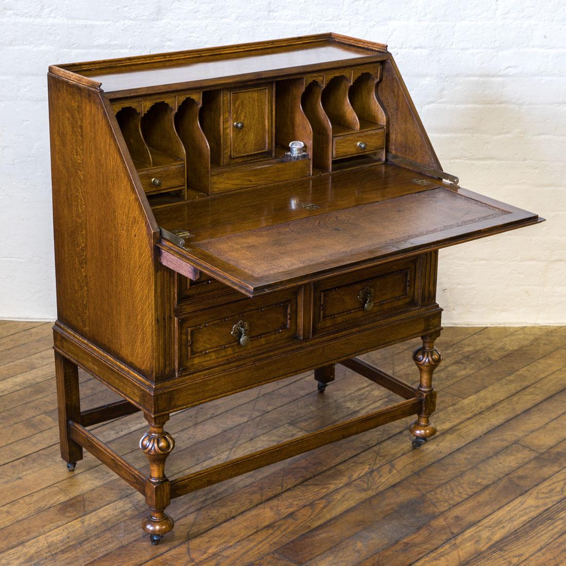 A good quality solid oak writing bureau from the Edwardian Period. The galleried top gives way to a double paneled fall with a very well fitted interior complete with the original leather writing surface. The lower half has two drawers above one