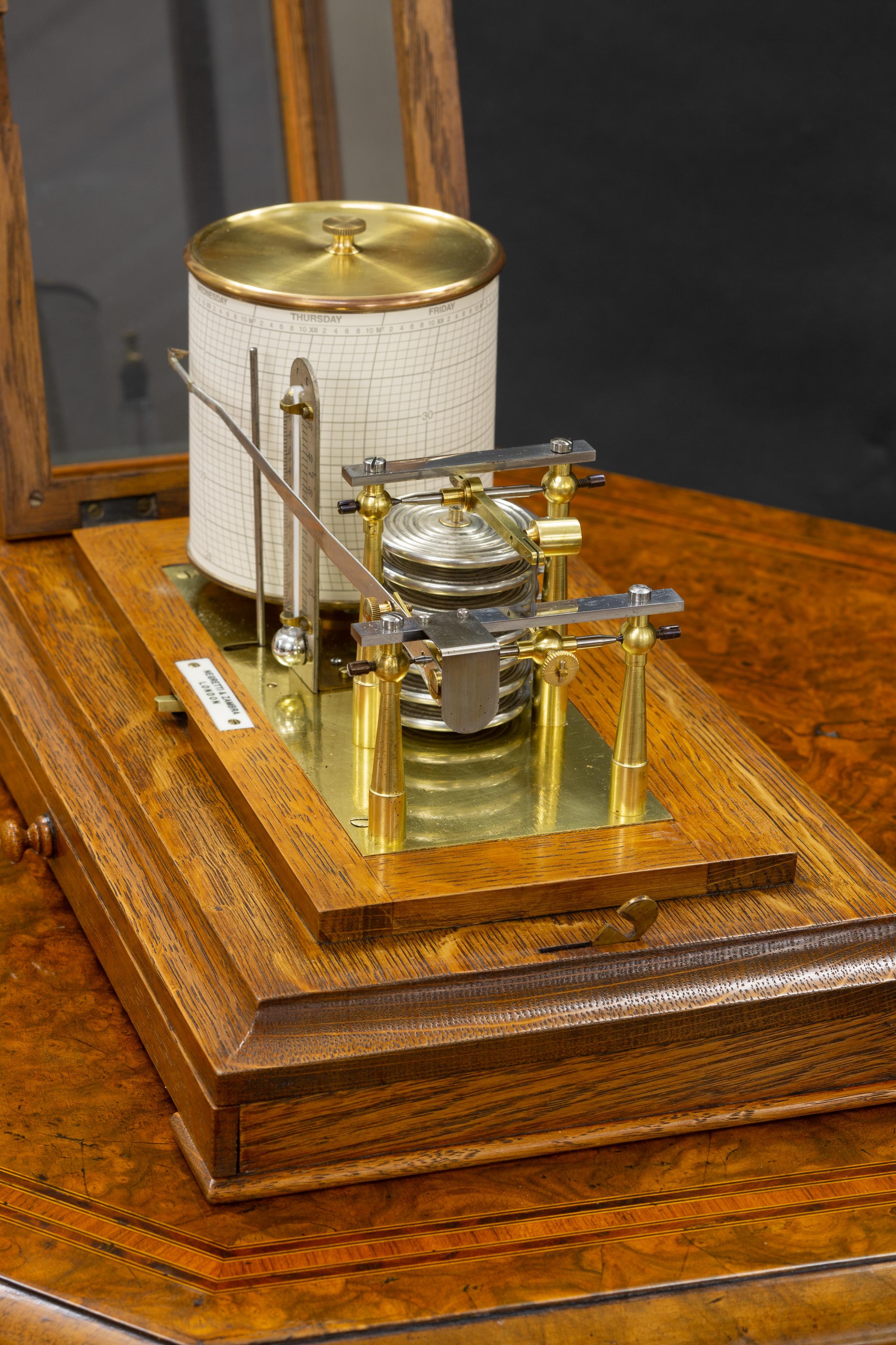 Negretti & Zambra


Fine Edwardian oak cased barograph with hinged lid, bevelled glass panels and central chart drawer.

Seven vacuum chambers linking the recording arm to the eight day movement to the revolving circular drum with lever