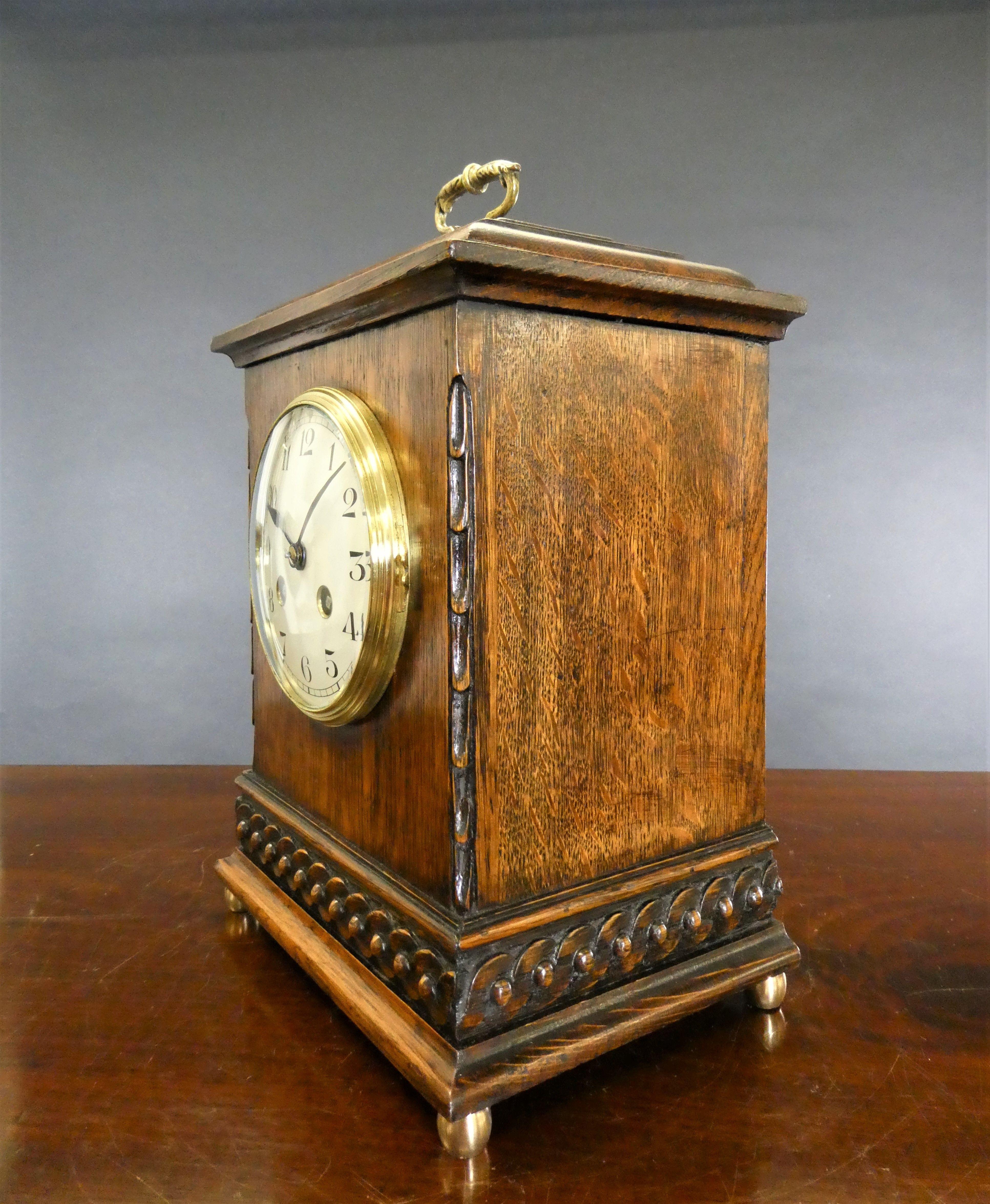 Oak cased mantel clock c.1900


Oak cased mantel clock, the case with stepped top surmounted by a decorative brass carrying handle. Applied carved decoration either side of the dial and carved, stepped plinth standing on four brass ball