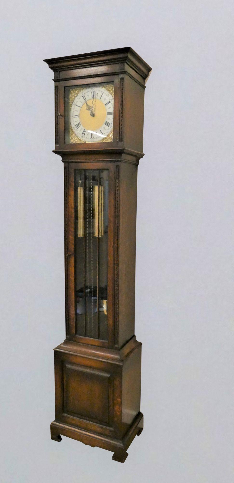 Edwardian Westminster Chiming Longcase Clock
 
Edwardian Longcase clock housed in an oak case, glazed front opening door with beaded decoration.  Raised, stepped plinth with central panel, flat top hood with beaded decoration to both sides of the