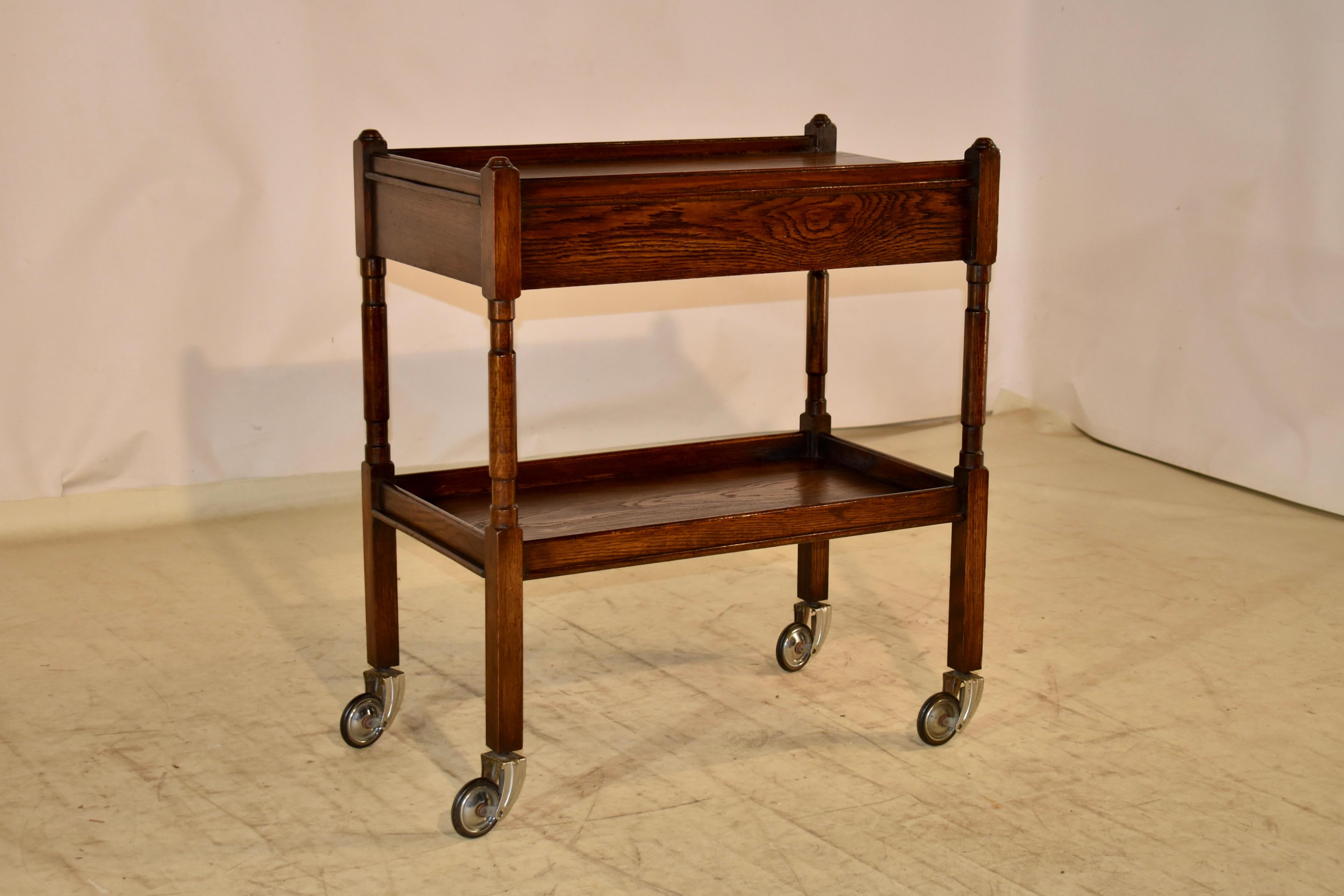 Edwardian oak drink cart from England, circa 1900-1910.  There is a single drawer in the top of the cart, which is a nice addition, and a more unusual feature to find in drink carts.  The top and lower shelf have galleries surrounding the shelves.