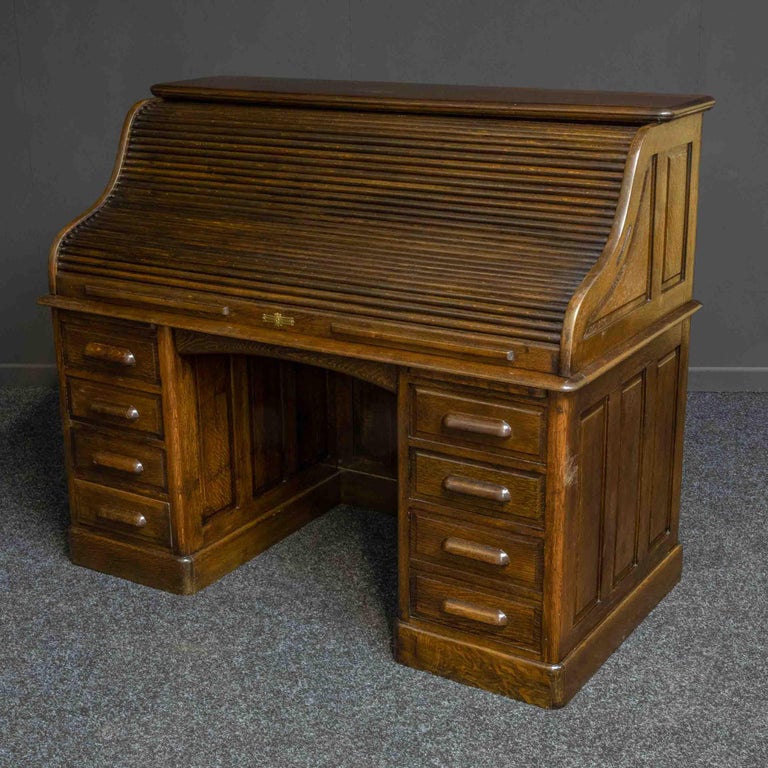 A good quality oak roll top desk from the Edwardian period. Recently re-polished to a dark oak finish as with most all roll top desks built to a superior standard, this one has fielded (beveled) panels to the back and sides. This allows the desk to