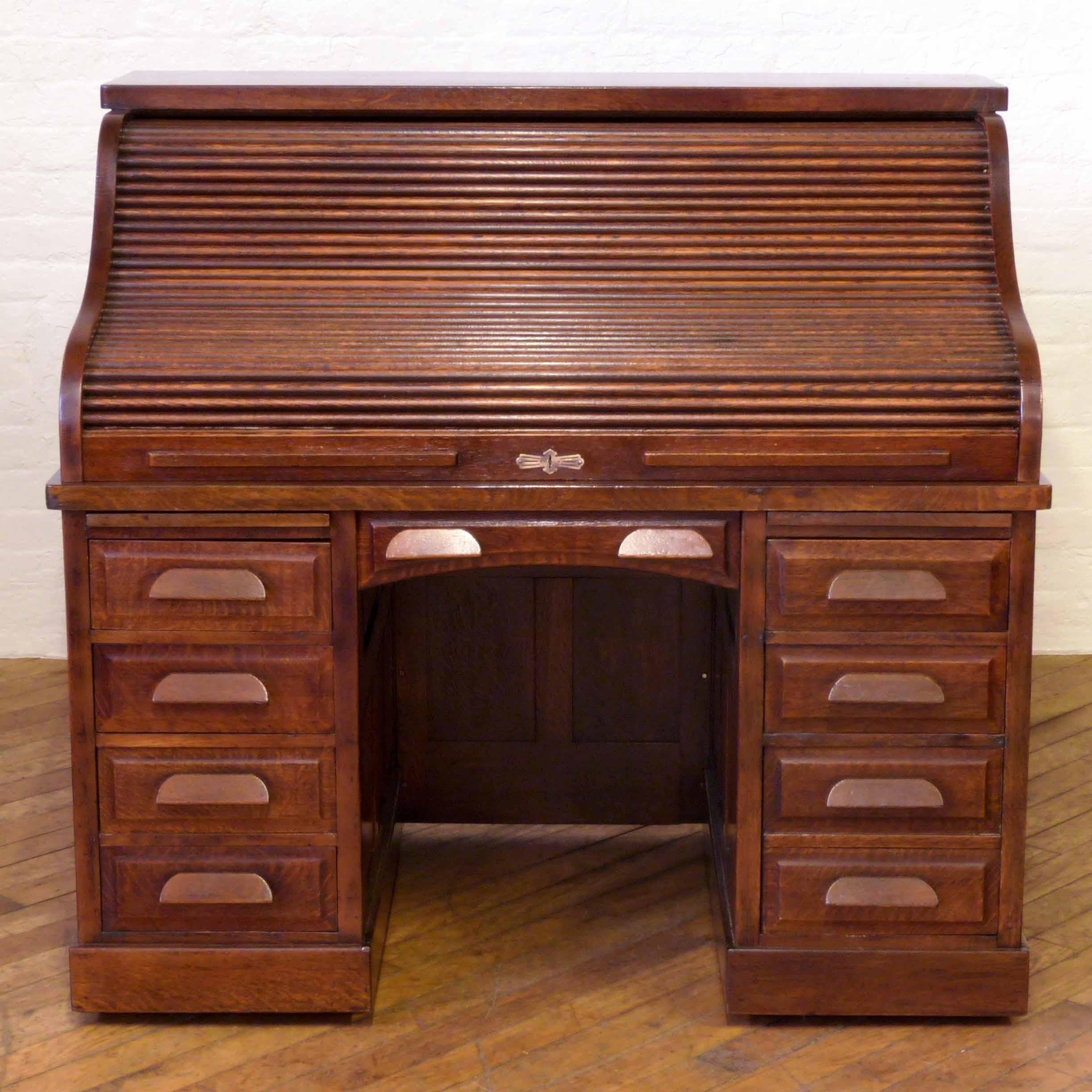 A superb large roll top desk with spectacular interior recently repolished to its original dark oak finish. With deep fielded (bevel edged) panels to the rear and sides. This desk looks fantastic to all sides. When closed, the roller shutter locks