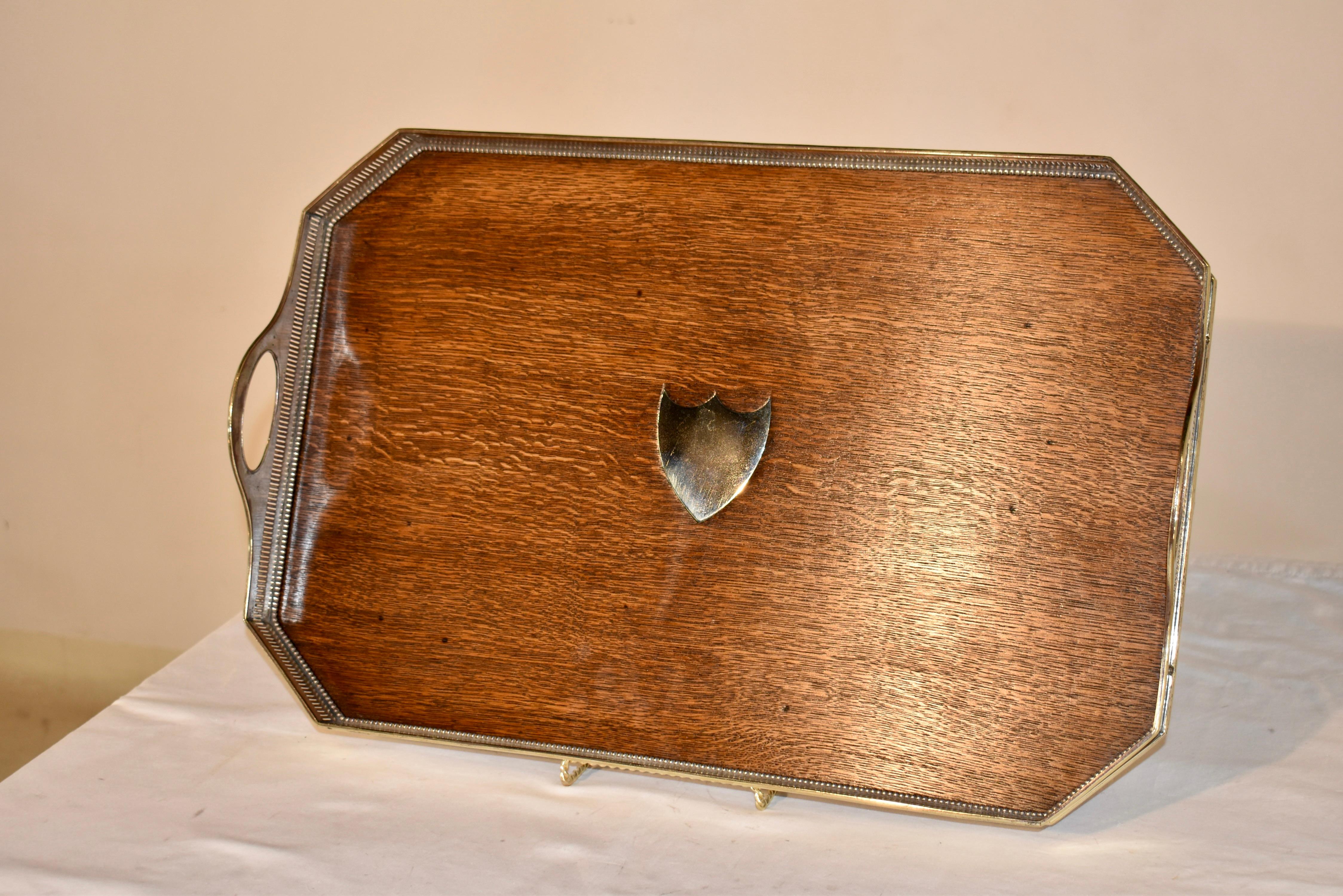 Circa 1900 English Edwardian oak tray with a lovely and statuesque silver plated gallery, which is pierced and molded along top and bottom edges for added design interest.  The handles are very sturdy, as this was most likely made for use as a tea