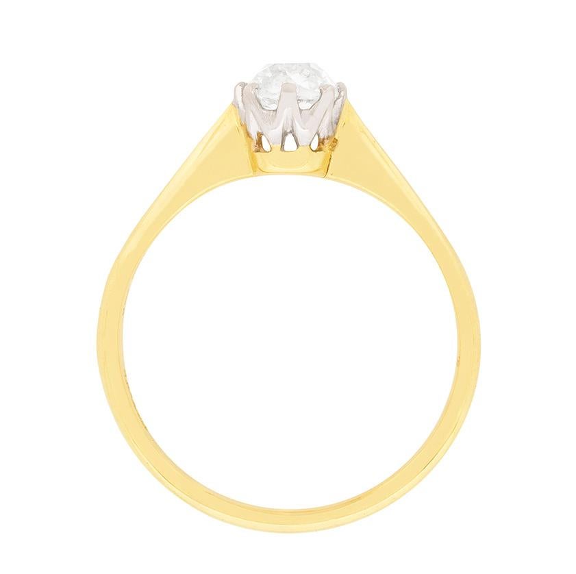 This classic solitaire features a beautifully hand cut diamond, which is a cushion cut shape. The sparkling stone weighs 0.65 carat and has been estimated as I in colour and VS2 in clarity. It is set within a platinum collet with eight claws. The