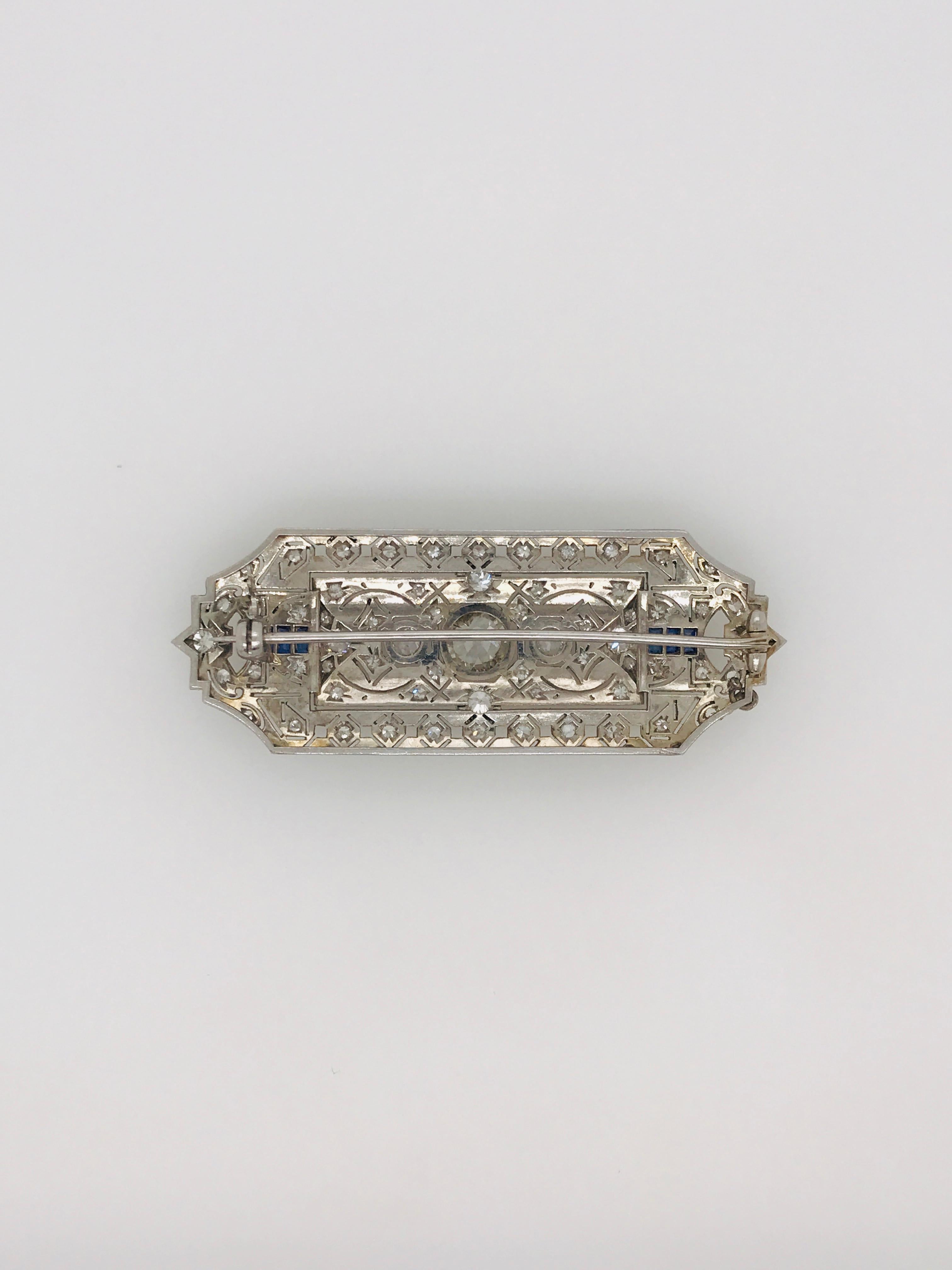 Original Edwardian Diamond And Sapphire Hand Pierced Brooch With Millegrained Borders.
There are 64 old cut diamonds with a total weight of approximately 3.10ct and 6 scissor cut sapphires set in platinum.
There is a 1.35ct I/J P1 old cut diamond in
