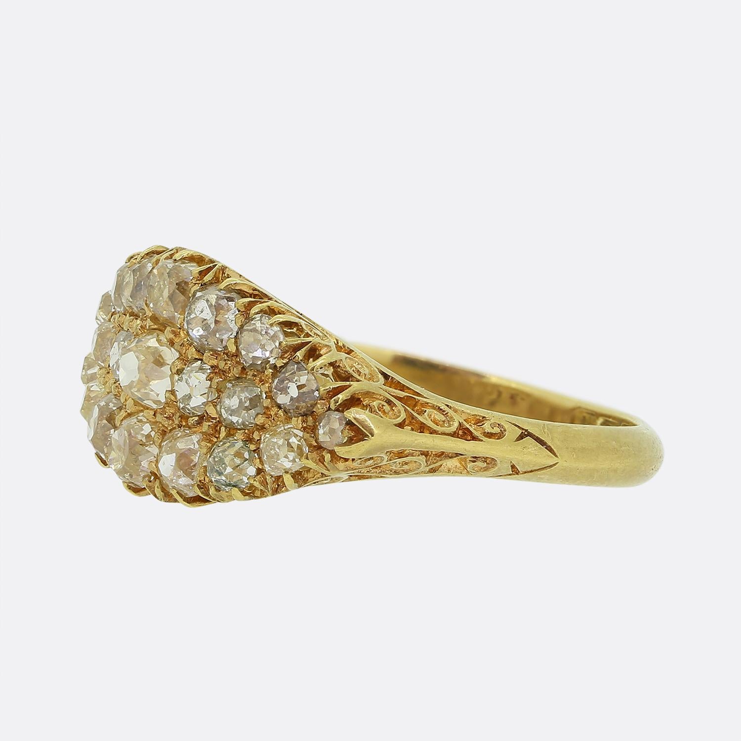 Here we have a wonderful old cut diamond ring dating back to the Edwardian period. This antique piece has been expertly hand crafted from a rich 18ct yellow gold with the face taking on a three row boat shape design. The face is then filled with a