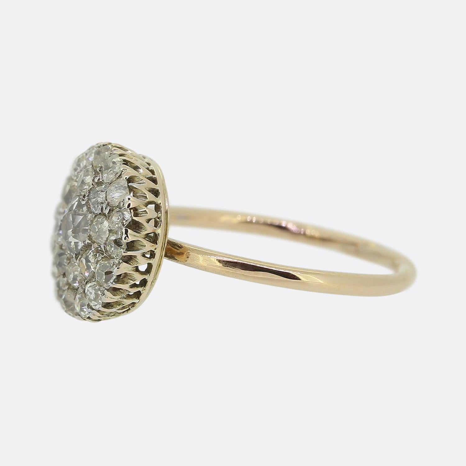 Here we have a beautiful diamond cluster ring from the Edwardian era. At the centre of the piece we find a single sizeable old cut diamond which is surrounded by two rows of smaller matching stones; all of which are set in platinum and sit atop a