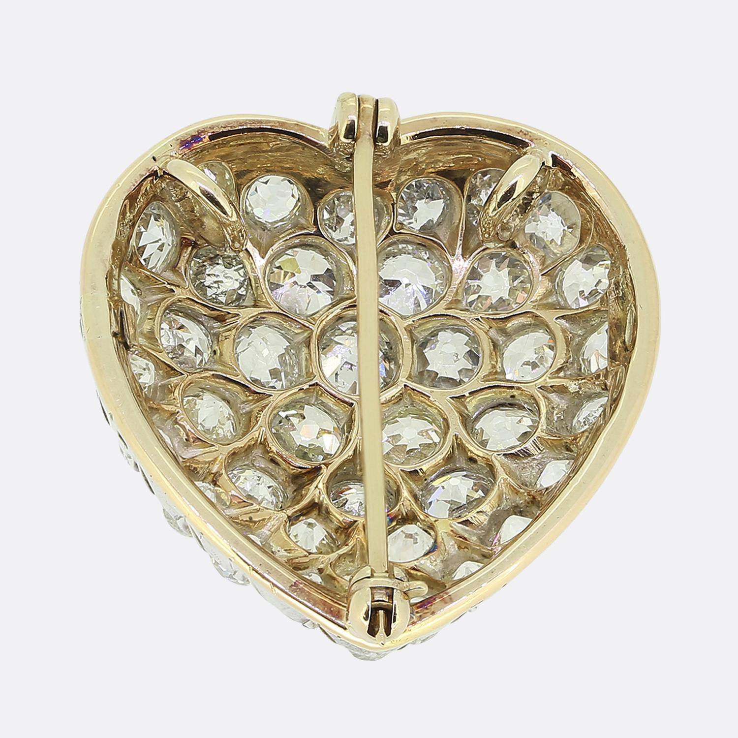 Here we have a delightful brooch taken from the Edwardian period. This piece has been crafted from a harmonious blend of 18ct yellow gold and platinum into the shape of a love heart and adorned with a stunning array of round faceted old mine cut