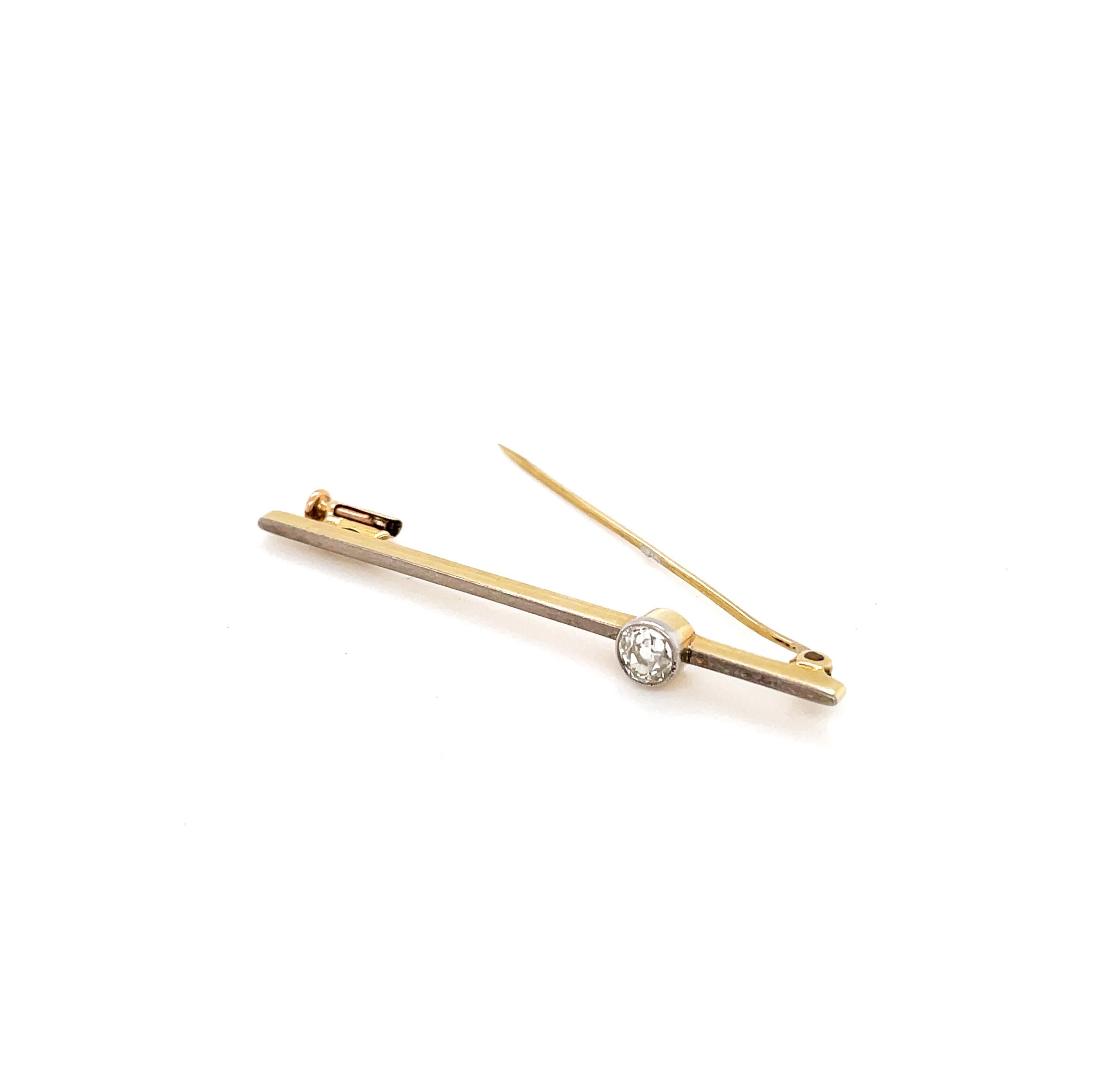 This gorgeous antique bar brooch features a rub over set old cut diamond weighing approximately 0.40ct. The stone is perfectly mounted in a platinum on 18 carat yellow gold bar brooch finished with a secure pin closure. The piece is beautifully