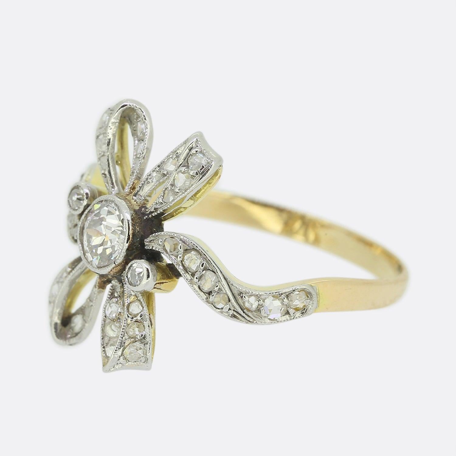 Here we have a wonderfully unique Edwardian diamond ring. At the centre of this piece sits a sizeable milgrain set old cut diamond which is flanked by two matching smaller stones. However, the piece really comes to life via its open structure which