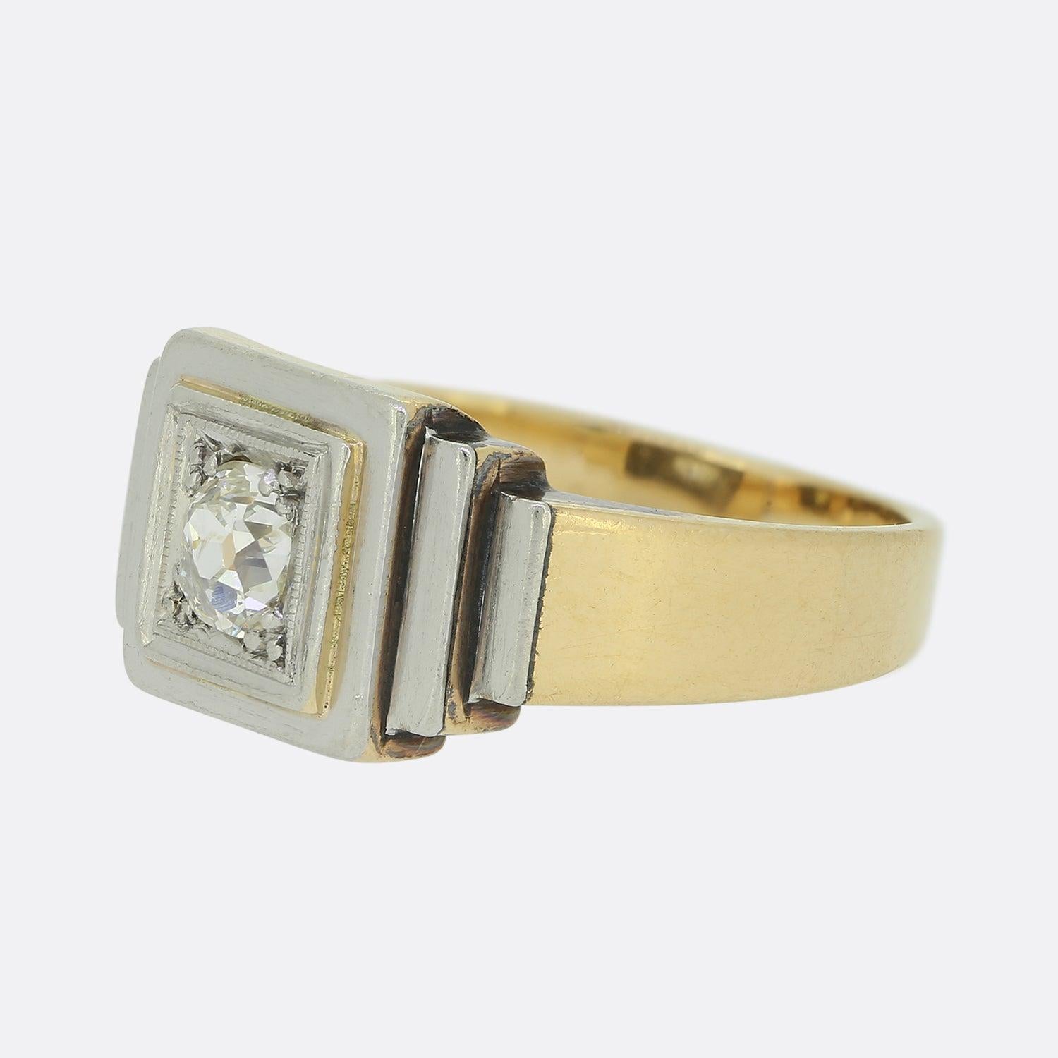 Here we have a sleek antique diamond gents ring. This piece takes on a square shaped face and showcases a single oval shaped old cut diamond within a fine white gold milgrain detailing. However, this piece gains its true character via its stepped