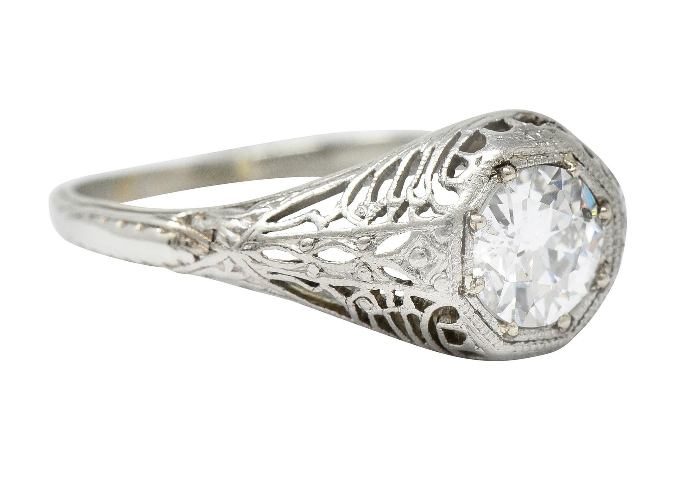 Centering old European cut diamond weighing approximately 0.90 carat - G color with SI2

Set low in an octagonal head of a pierced bombè style ring

Gallery is engraved with a radiating burst motif

Stamped 19K for 19 karat gold

Maker's mark for