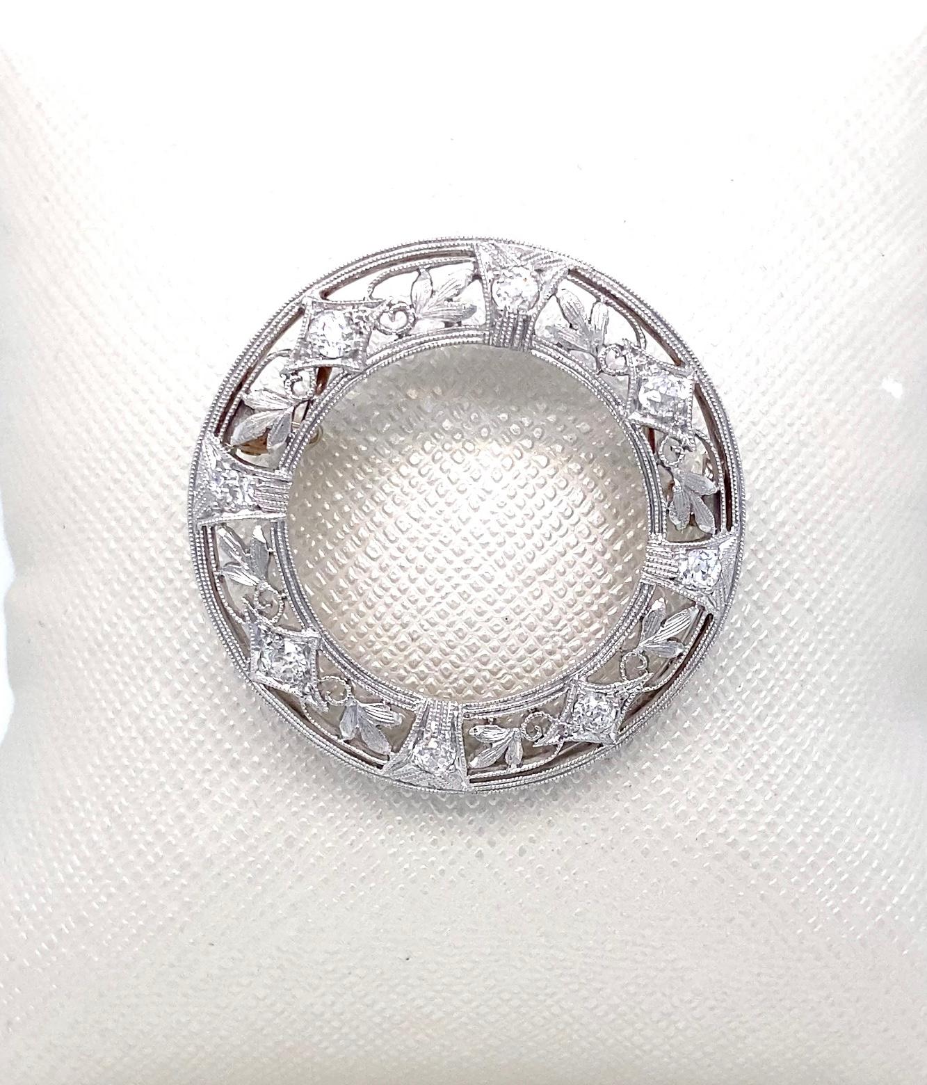 This vintage Edwardian platinum and diamond pendant harkens back to the first decade of the twentieth century and the French La Bell Epoque style. The pin features a mix of sparkling old mine-cut and old European-cut diamonds for a total of eight