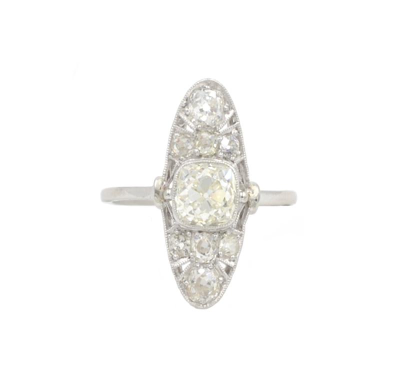 Edwardian antique diamond and platinum elongated ring from circa 1915.  This beautiful ring features a center 1.15 carat Old Mine Cut diamond that is K-L in color and VS2 in clarity.  Eight Old Mine Cut side diamonds are set throughout the ring for