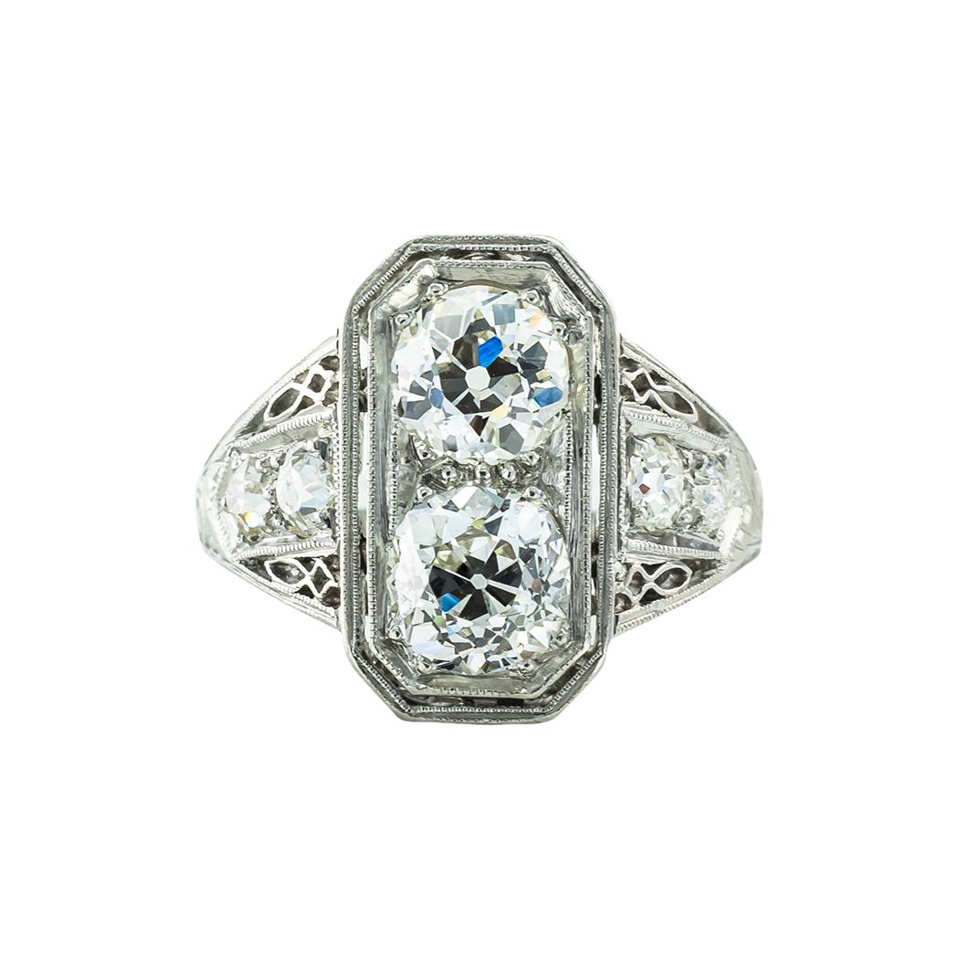 Edwardian old mine-cut diamonds and platinum toi-et-moi engagement ring circa 1910.  

SPECIFICATIONS:

LARGE DIAMONDS:  two old mine-cut diamonds together weighing approximately 1.35 carat, approximately H-I color, VS clarity.

SMALL DIAMONDS: 