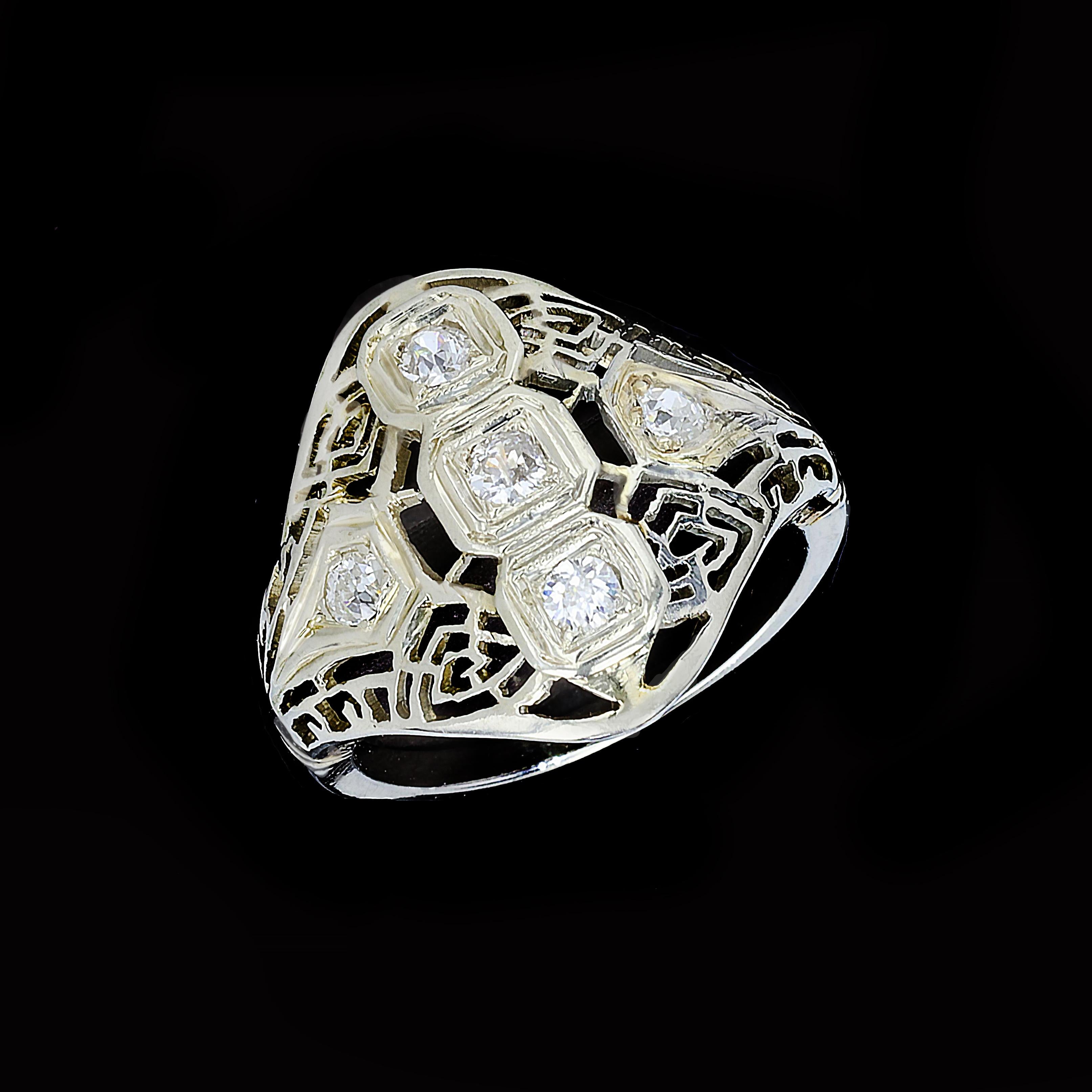 Beautifully intricate open framework in 14K white gold provides a gorgeous base for five old mine cut diamonds in this breathtaking Edwardian ring. The old mine cut diamonds weigh approximately 0.25ct. with a color of H and VS2 clarity. The ring