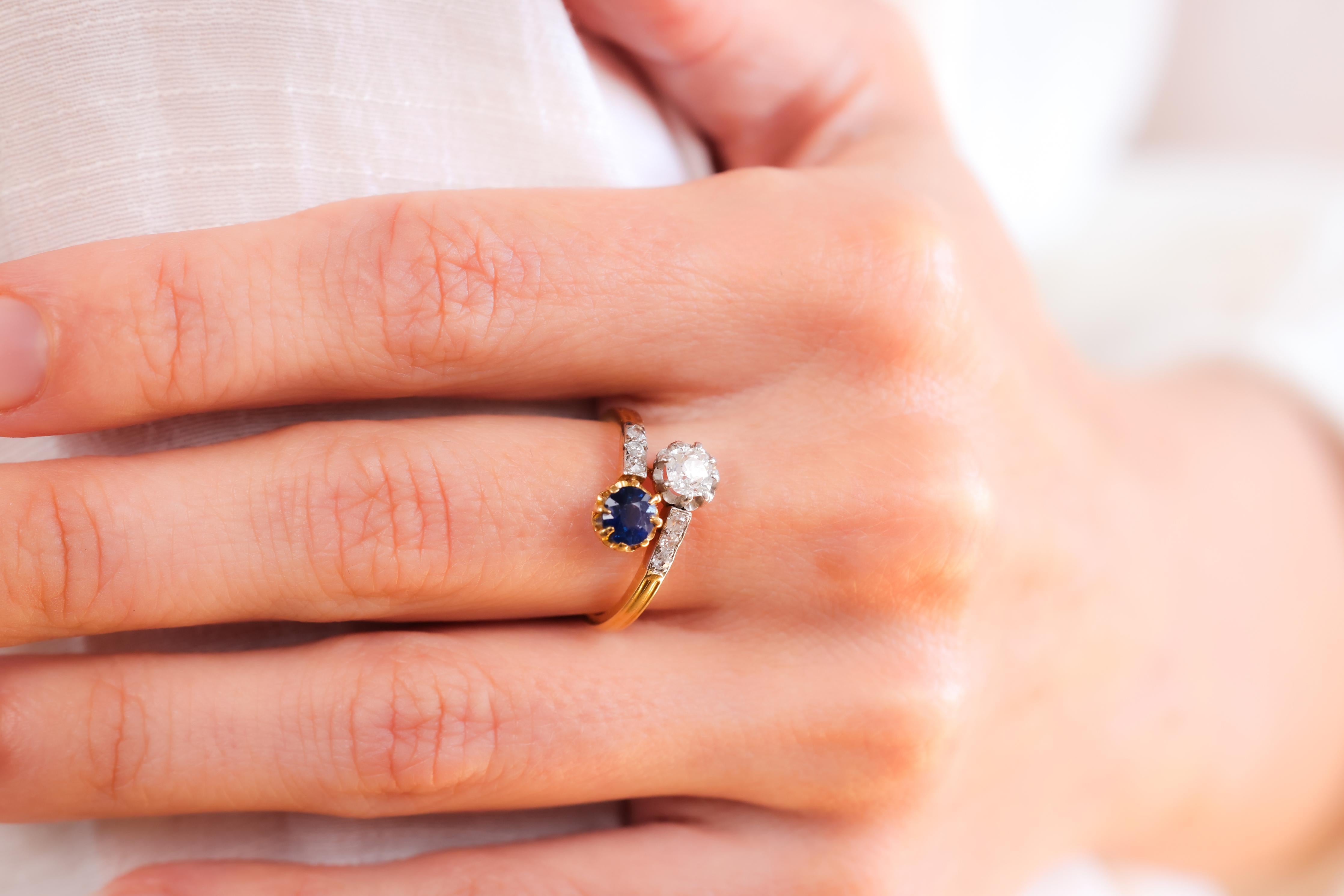 Center Stone: Diamond
Cut: Old Mine
Weight: Approximately 0.4 Carats
Color: F-G
Clarity: SI
Accent Stone: Sapphire
Cut: Round
Weight: Approximately 0.6 Carats
Color: Blue
Accent Stone: 6 Diamonds
Cut: Old European Single Cuts
Weight: 0.15