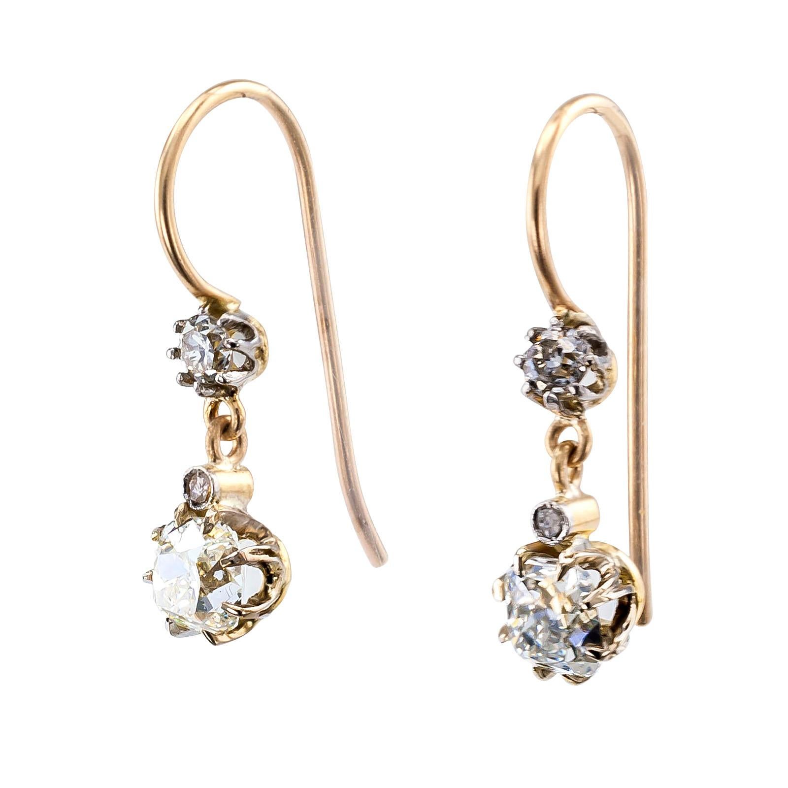 Edwardian old Mine-cut diamond and gold drop earrings circa 1910.

DETAILS:

DIAMONDS: two old Mine-cut diamonds together weighing approximately 1.11 carats, approximately I – K color and VS clarity, four smaller diamonds totaling approximately 0.17