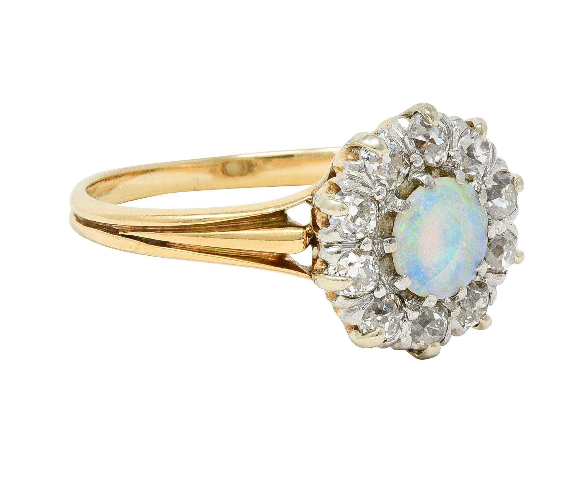 Centering a 4.5 mm round opal cabochon - translucent white with spectral play-of-color
Prong set in a platinum-topped head with a halo surround of old European cut diamonds
Weighing approximately 0.40 carat total - eye clean and bright
Prong set and