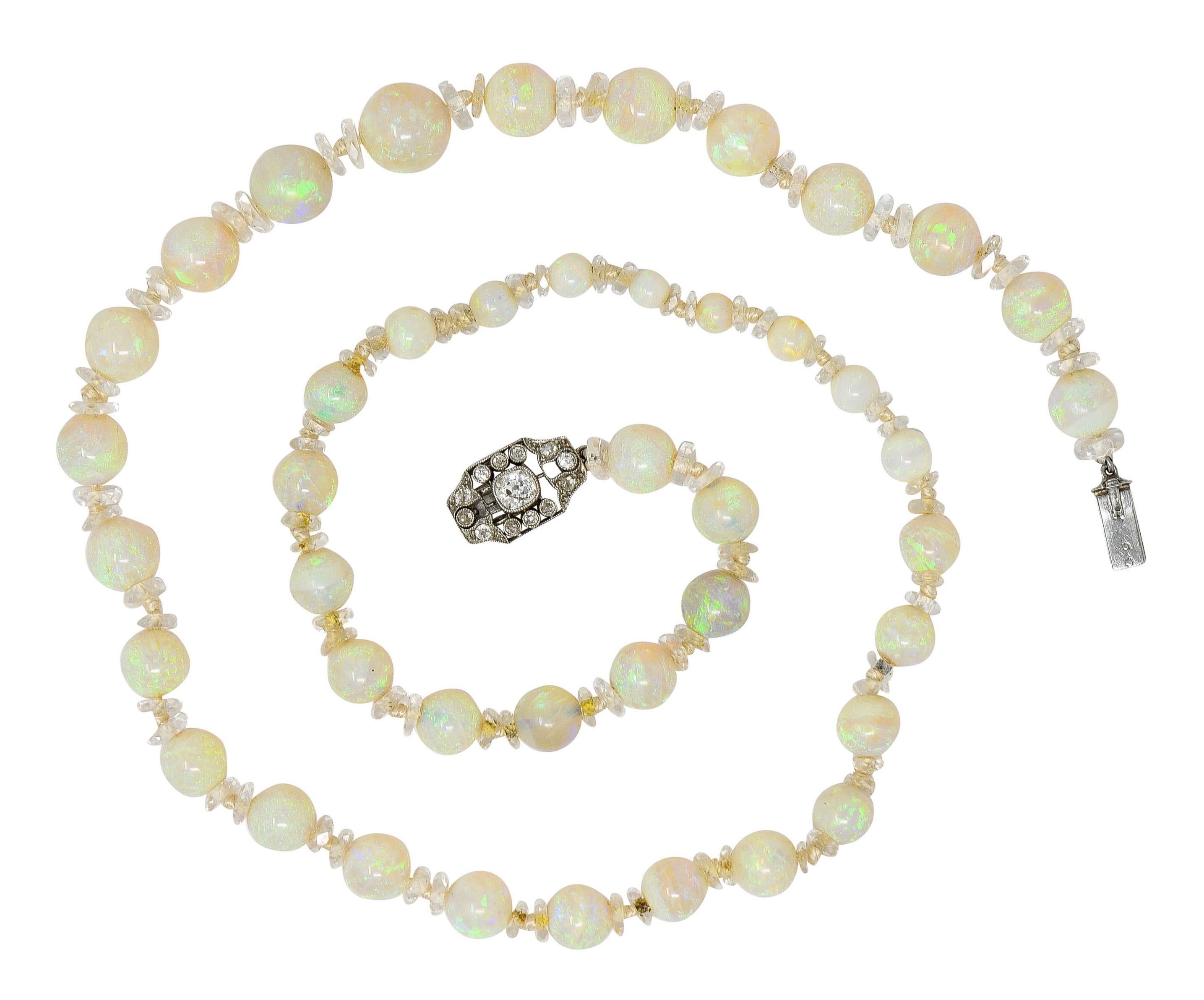 Strand necklace is hand-knotted with opal beads alternating with rock crystal rondelles

Opals graduate in size from 10.2 mm to 4.5 mm with well matched white body color

Varying in transparency and exhibiting moderate to very strong green, blue,