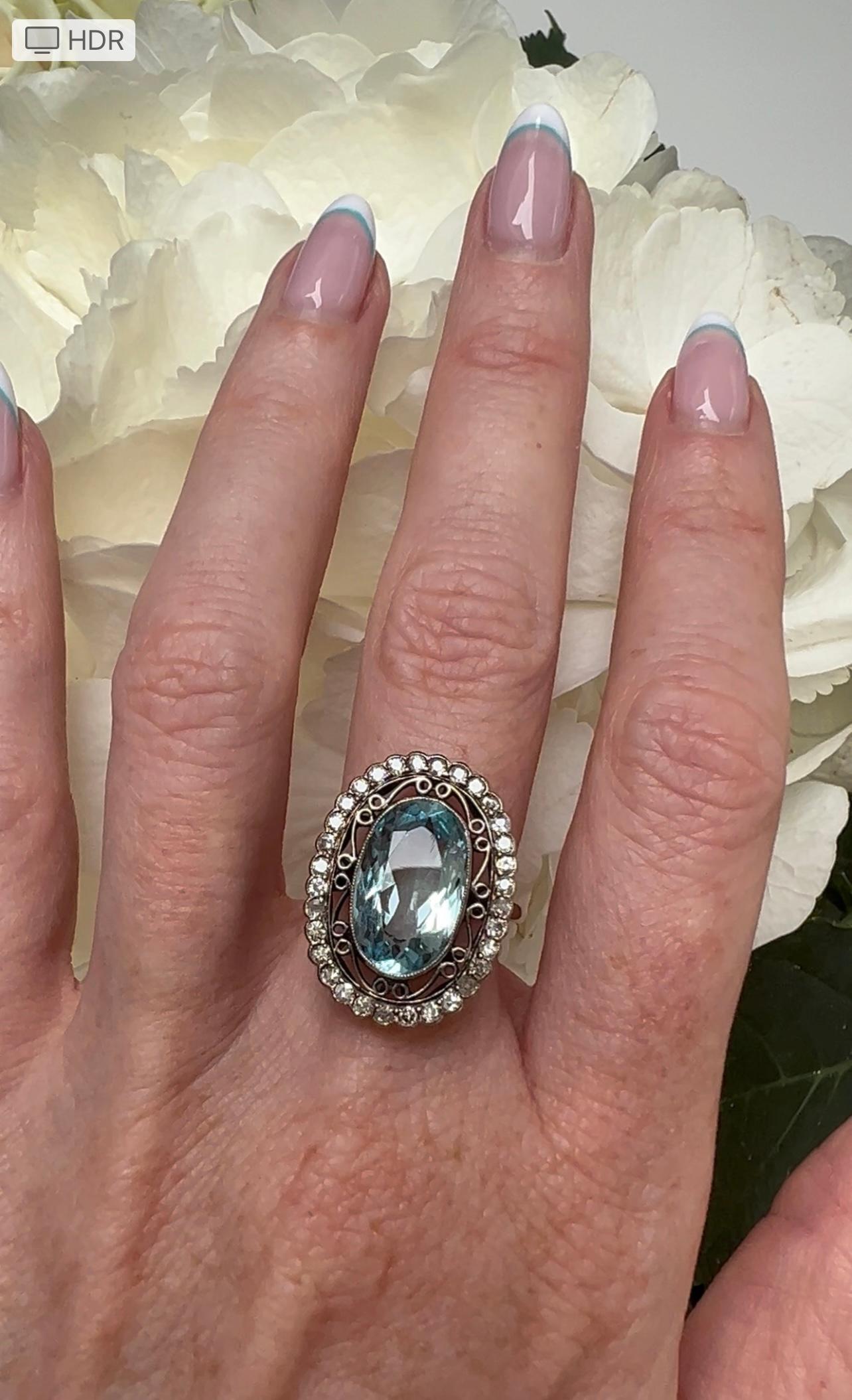 Edwardian oval aquamarine and diamond ring. Aquamarine measures 14x8.5mm, Approx 3cts surrounded by old cut diamonds, Approx 0.35cts, set in 18ct gold. Size 6.25/M.5 but can be resized. 