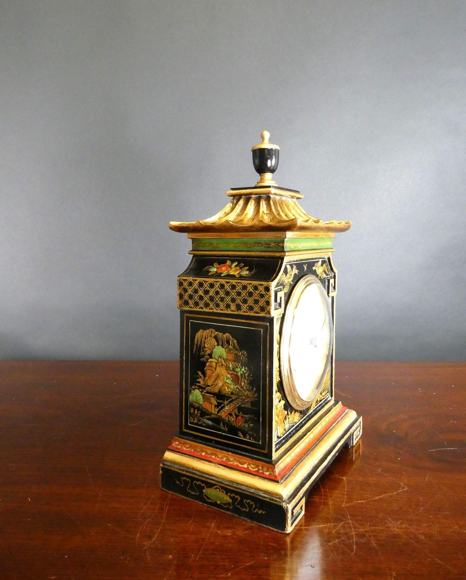 Edwardian Pagoda Top Chinoiserie Decorated Mantel Clock

Edwardian mantel clock housed in a pagoda top case with raised chinoiserie scenes on a black ground, coloured decorated band to the top and plinth and standing on decorated block feet. The