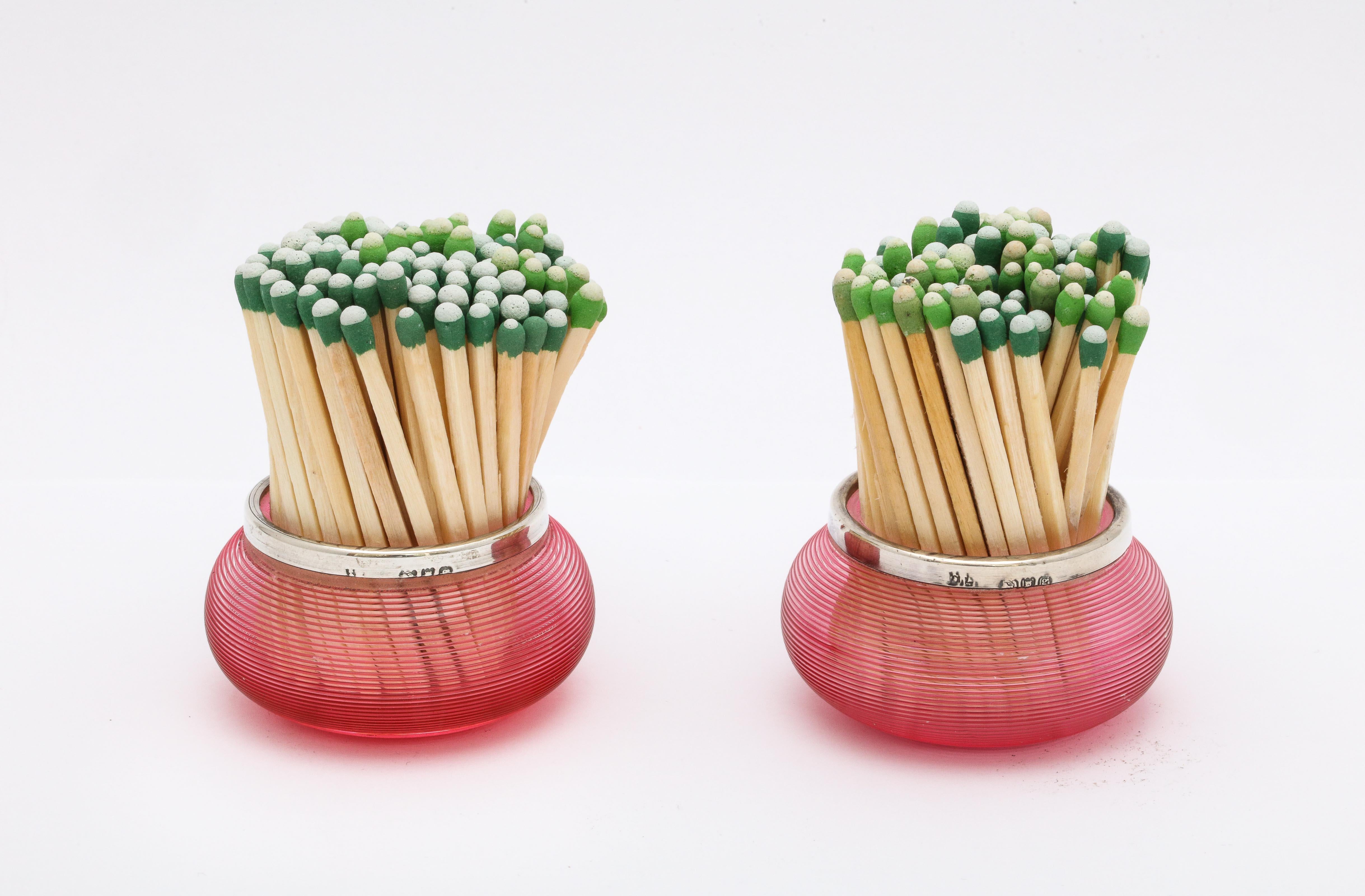 Edwardian pair of sterling silver-mounted cranberry/red threaded crystal match strikers, London, 1902, David Loebl - maker. Each match striker measures 1 1/4 inches high x 2 inches in diameter at widest point. Dark spots in photos are reflections.
