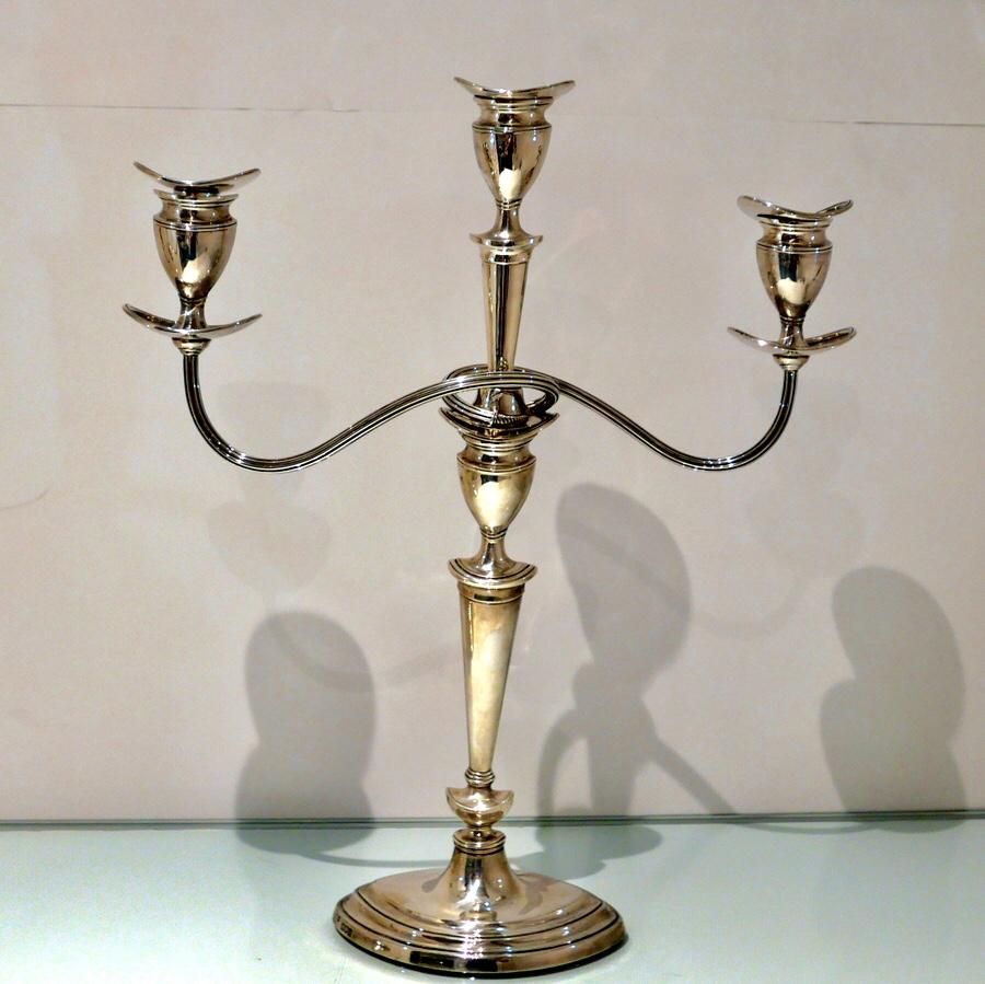 A stylish pair of sterling silver three light plain formed oval candelabra designed with elegant tapering features throughout. The elegant branches are detachable.

Measures: Height 19 inches/48.25cm

Width 16 inches/41cm (spread of