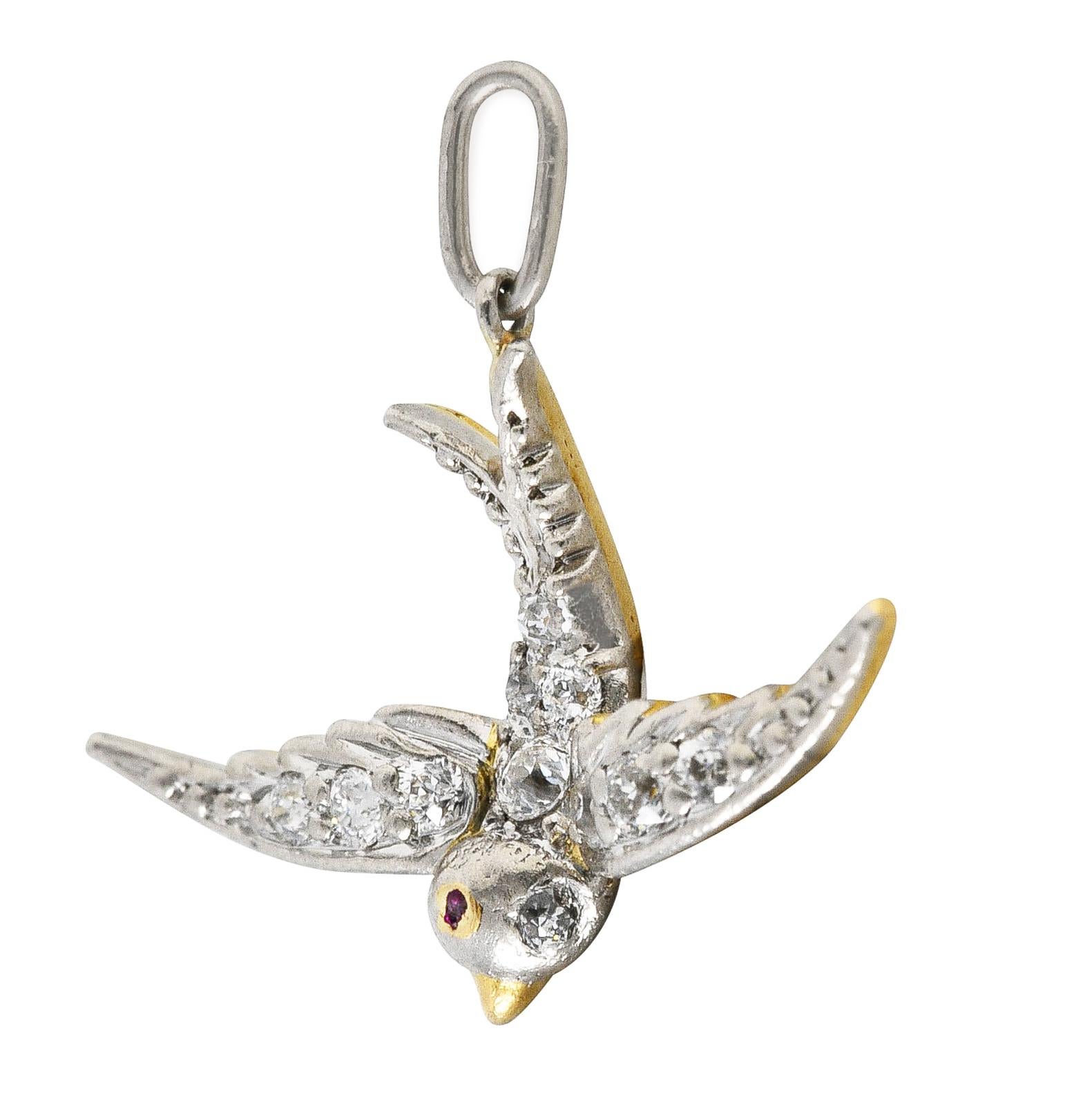 Charm is designed as a swallow mid-flight with spread wings and a split tail. Symbolic of love since they mate for life and are thought to guide sailors home. Pavè set in platinum with old European cut diamonds weighing in total approximately 0.25