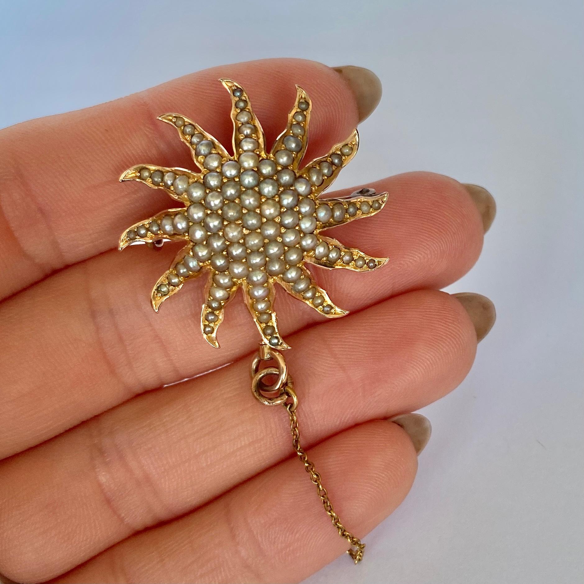 This stunning sun is adorned with pearls which are complimented perfectly by the bright yellow 15ct gold. On the back there is a pin which is very secure and a fold away loop to make this perfect for hanging off a chain!

Star Diameter: 30mm