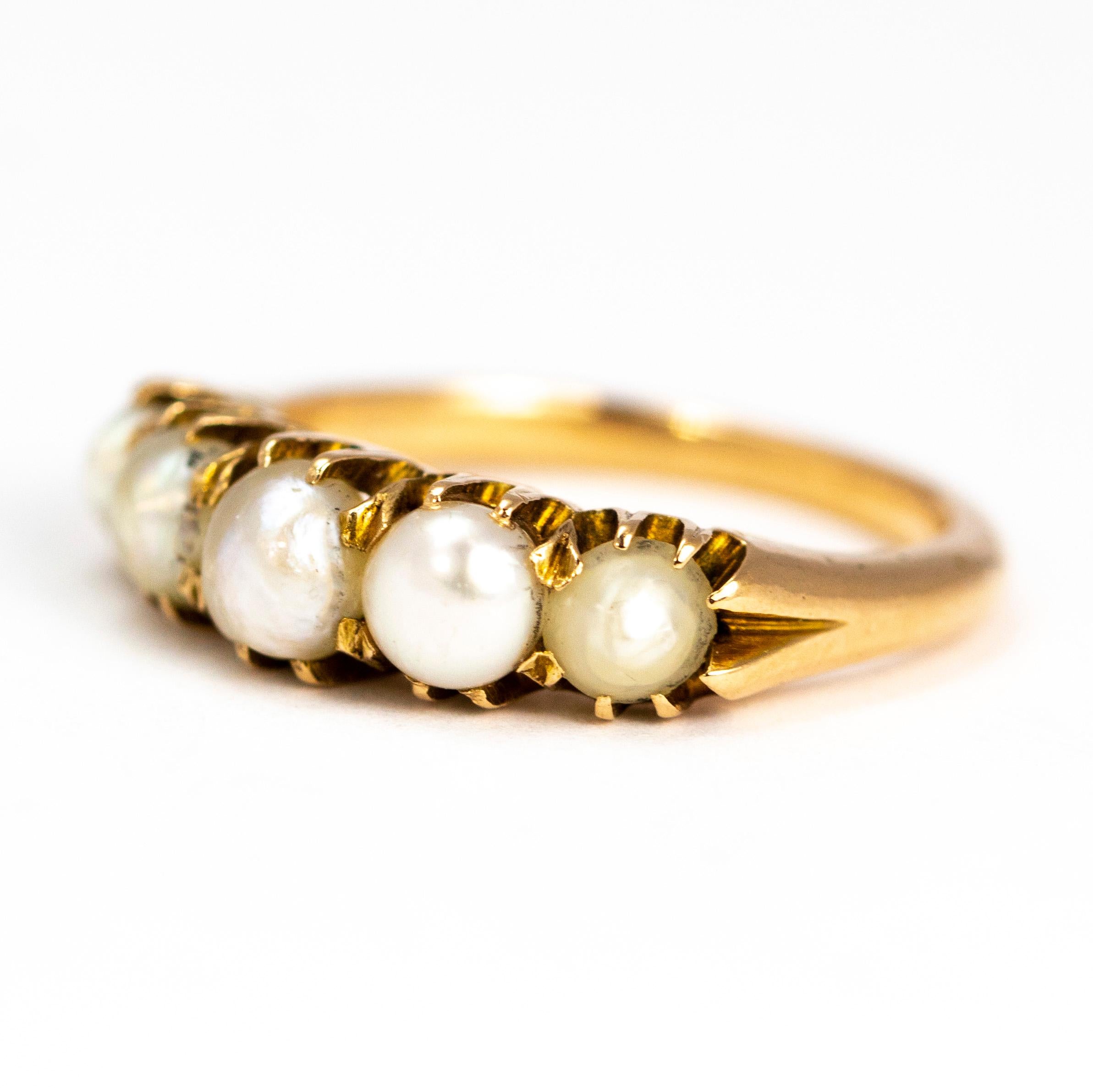 This pearl five stone ring has a chunky feel to it and is modelled in glossy 9carat gold. The pearls are se in simple claws.

Ring Size: L 1/2 or 6 
Band Width: 5mm

Weight: 4.7g