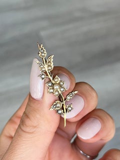 Broche eduardiano de perlas y flor de oro de 9 quilates