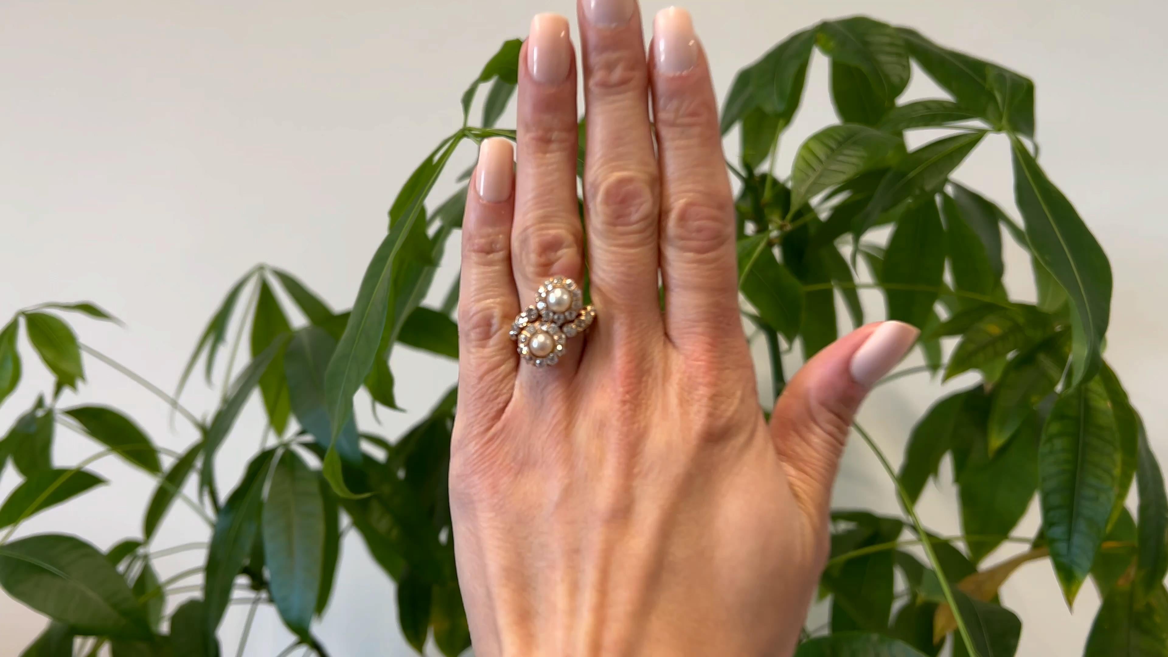 One Edwardian Pearl and Diamond 14k Rose Gold Toi et Moi Ring. Featuring two pearls. Accented by 28 old mine cut diamonds with a total weight of approximately 2.50 carats, graded near-colorless, SI-I1 clarity. Crafted in 14 karat yellow gold with